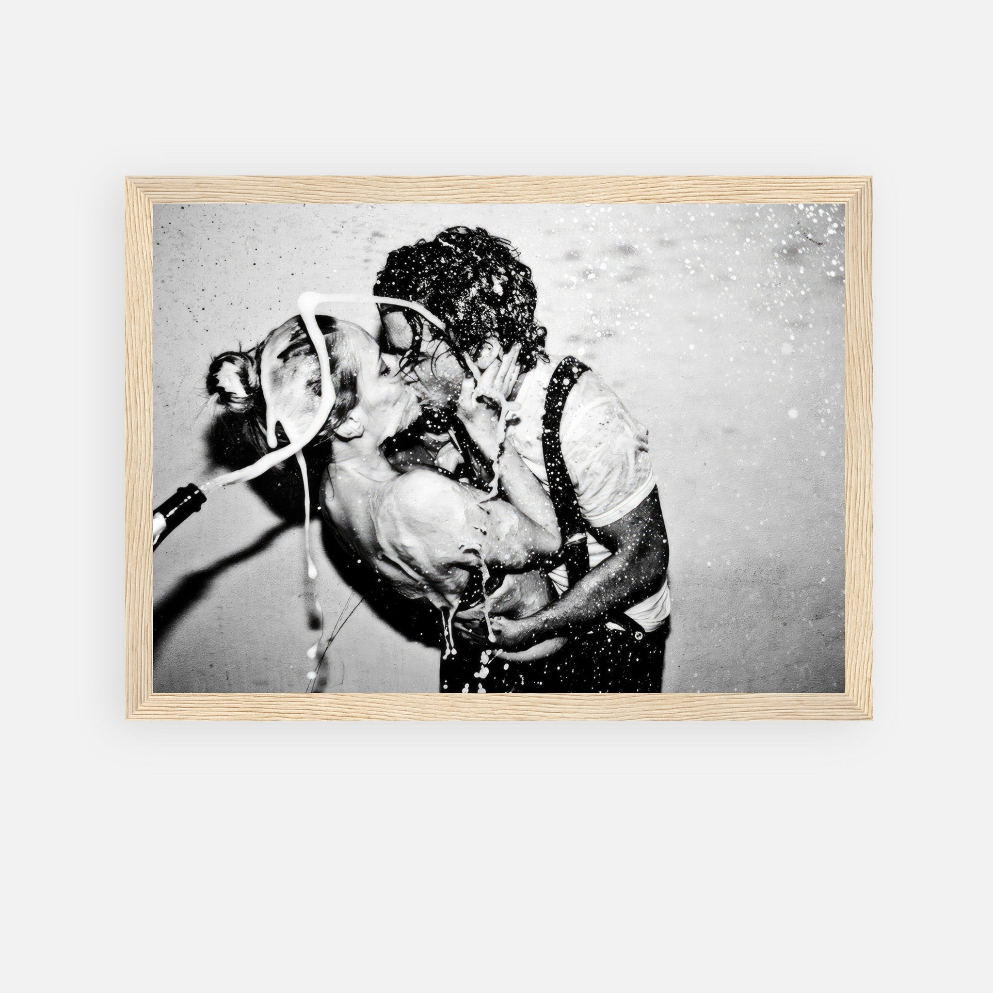 Framed print of Johnny Depp and Kate Moss sharing a passionate kiss amidst champagne spray.