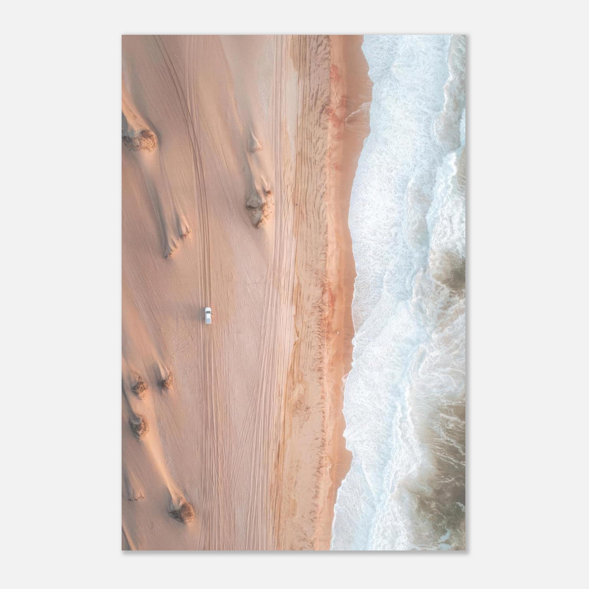 Aerial view of desert sands meeting ocean waves in stunning drone photography metal print.