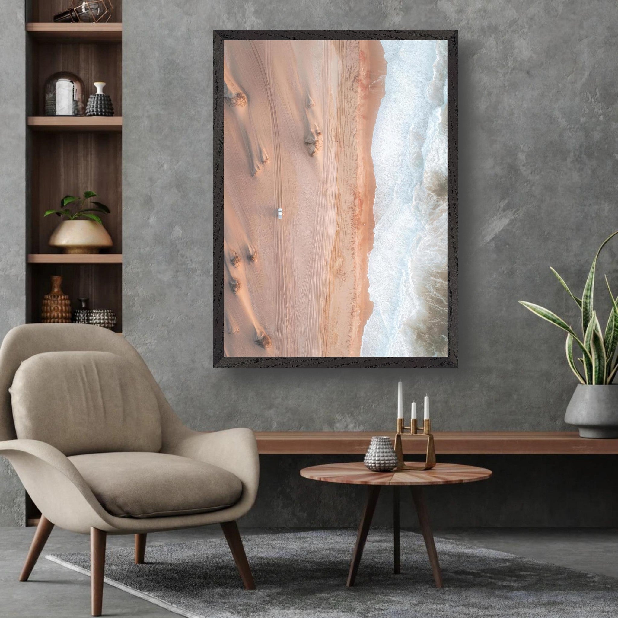 Aerial view of golden dunes meeting the ocean in a framed fine art drone photograph, displayed in a stylish living room.