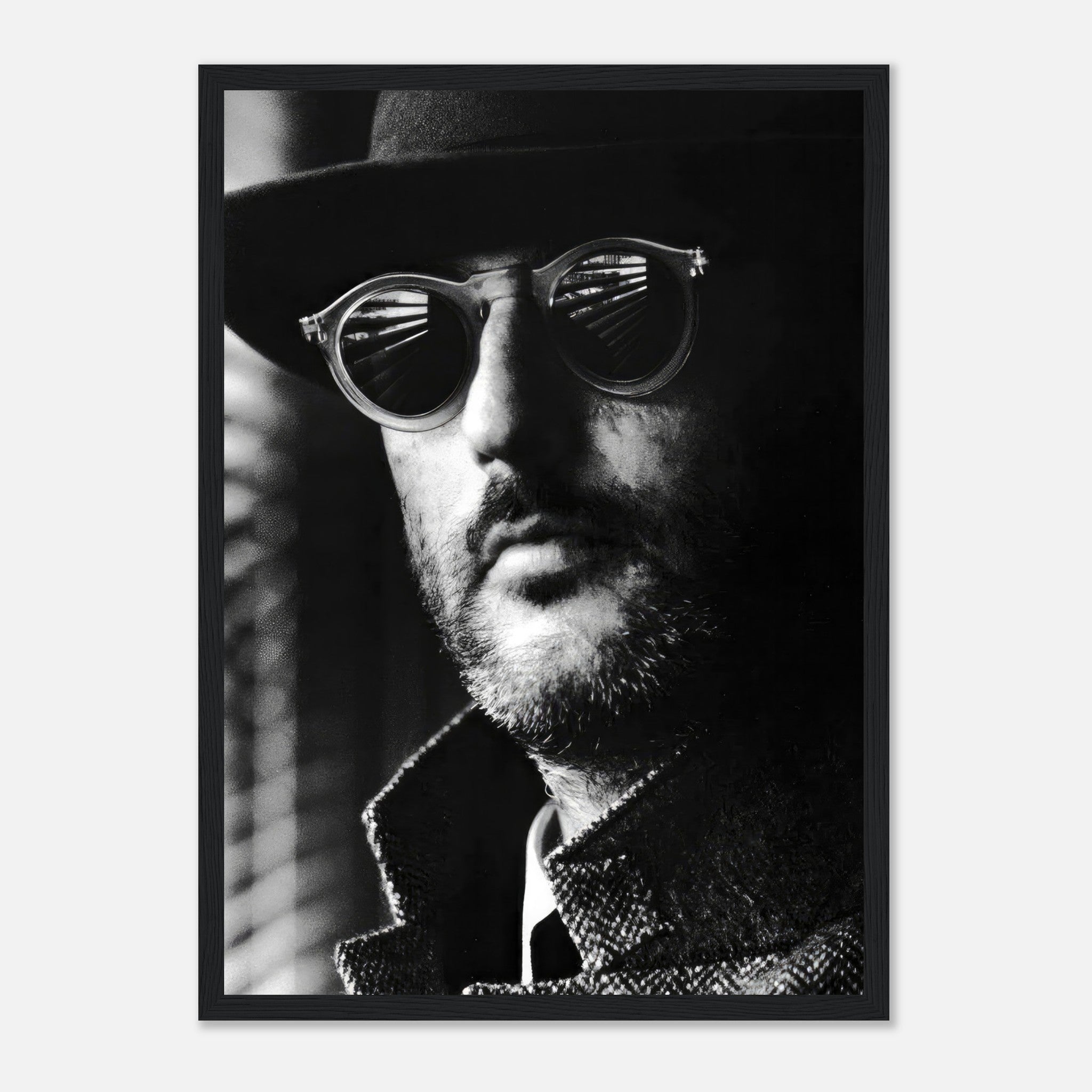 Jean Reno Leon Photography framed print showcasing a mysterious man in sunglasses and a stylish coat in black and white.