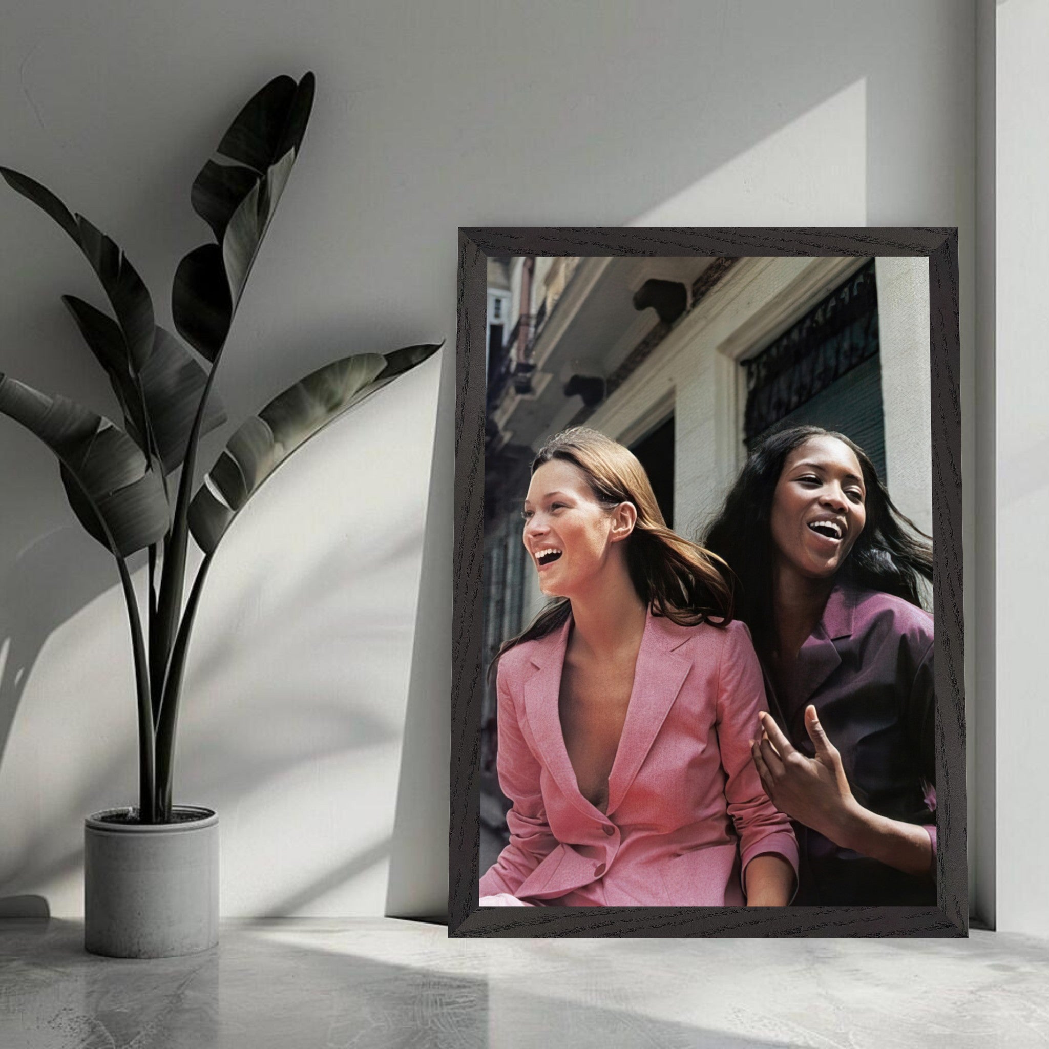 Naomi Campbell x Kate Moss vintage framed print showcasing iconic supermodels in candid moment, enhancing any interior decor.