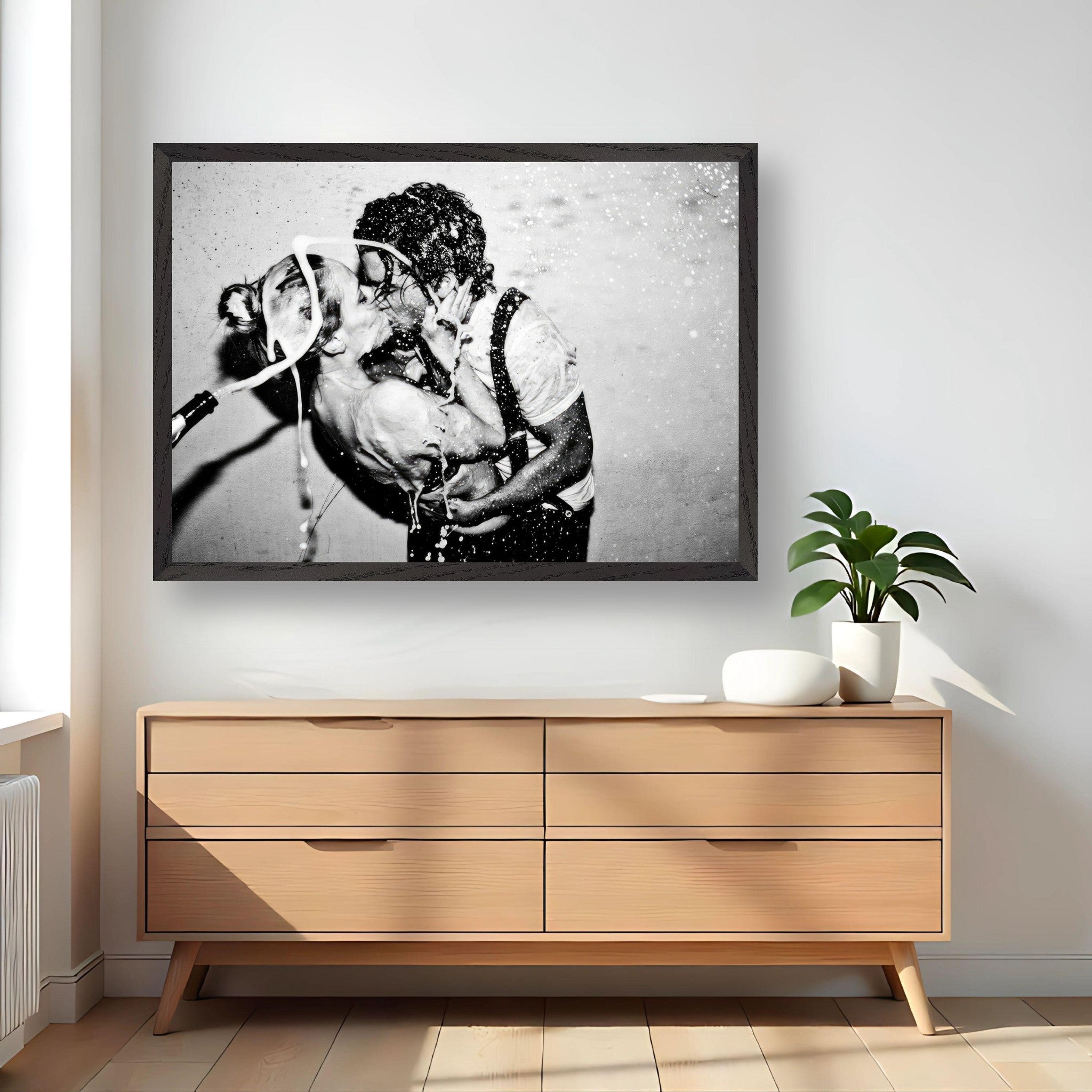 Black-and-white fine art print of Johnny Depp and Kate Moss sharing an intimate kiss, framed on a stylish wall.