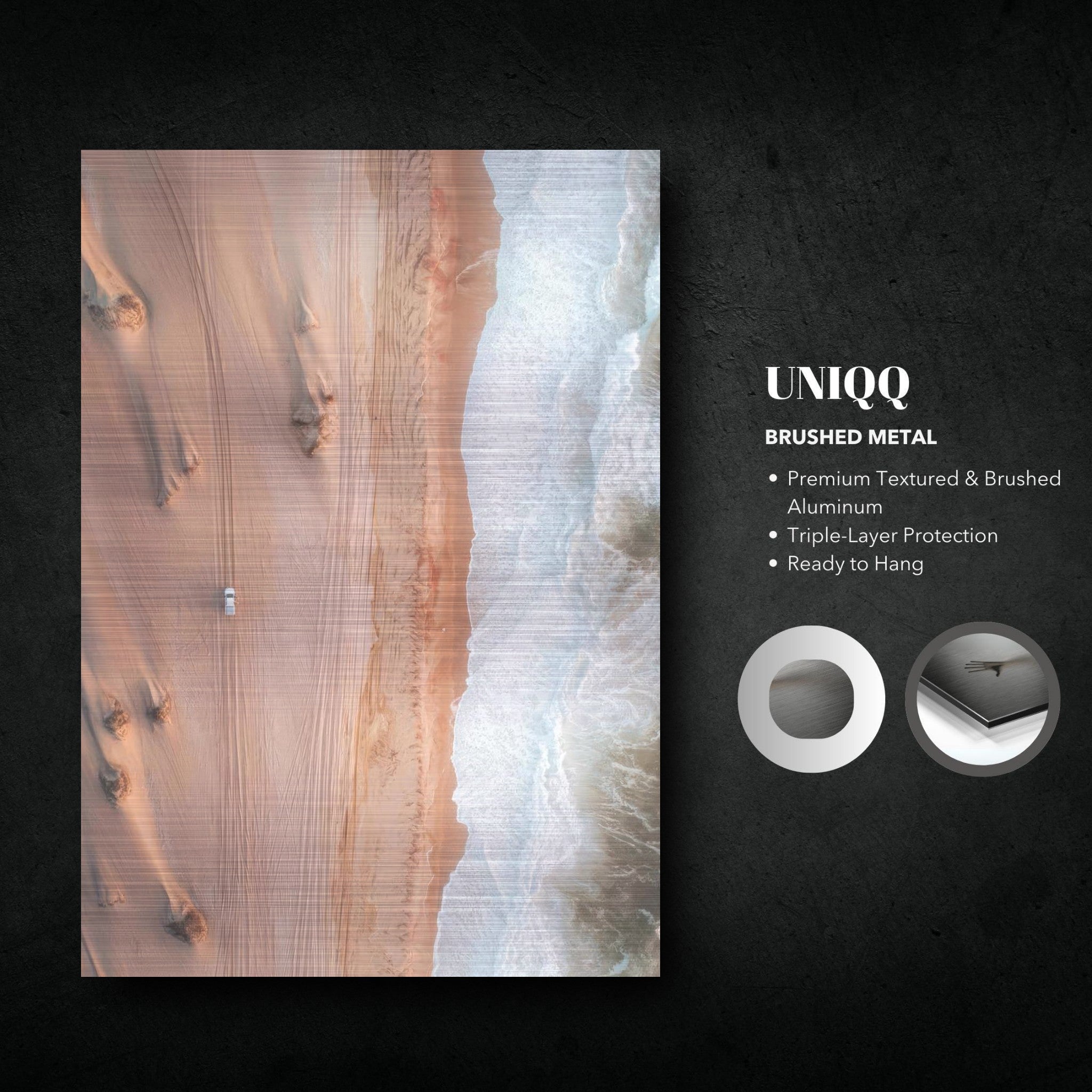 Stunning brushed metal print of drone photography depicting the contrast of desert dunes and ocean waves.