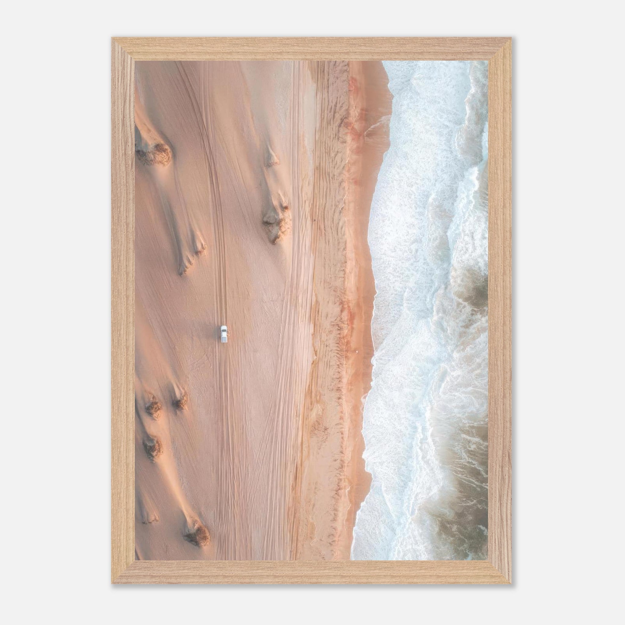 Vintage framed print of desert meeting ocean in stunning drone photography, showcasing sand dunes and ocean waves.