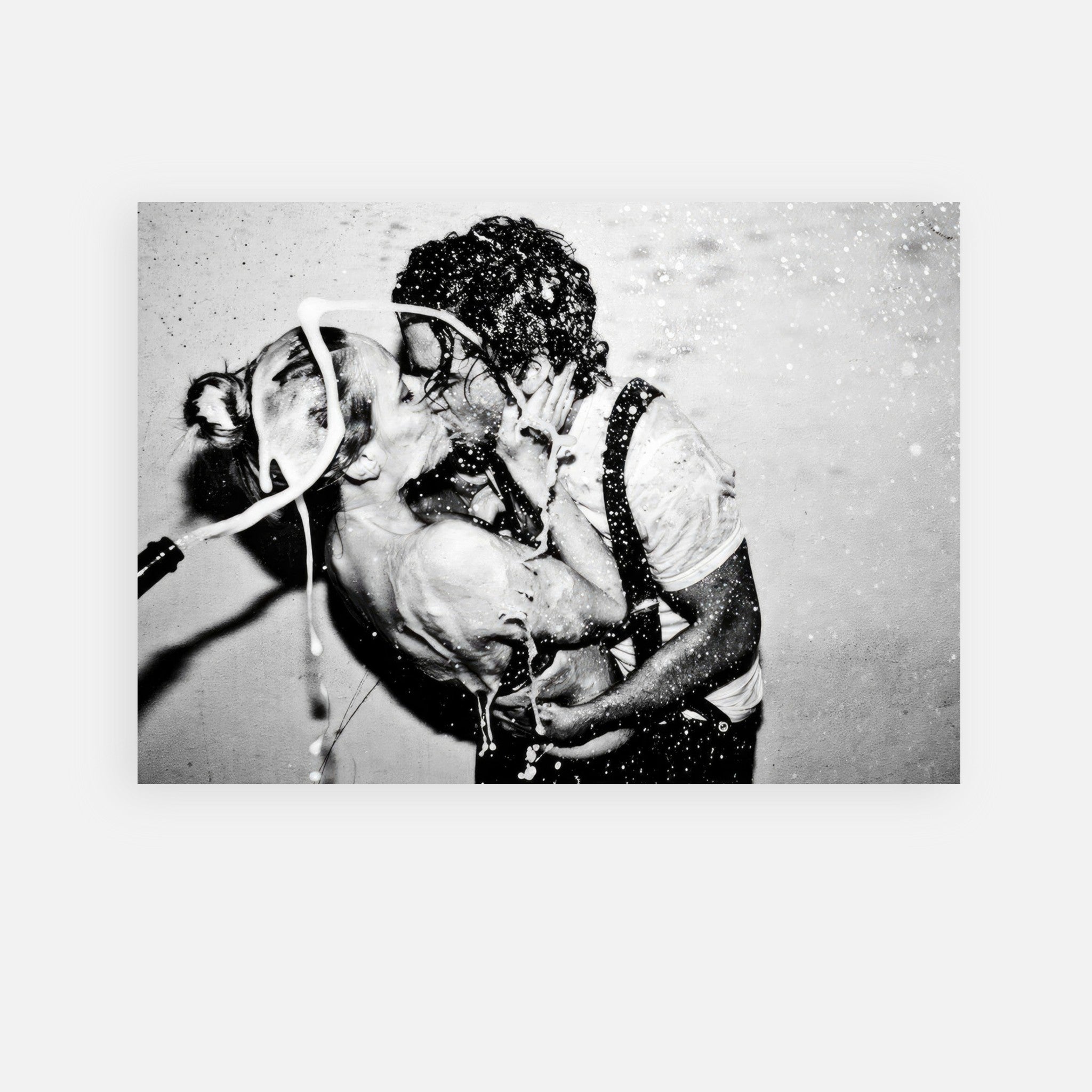 Black-and-white poster of Johnny Depp and Kate Moss sharing a passionate kiss, captured in a moment of celebration.