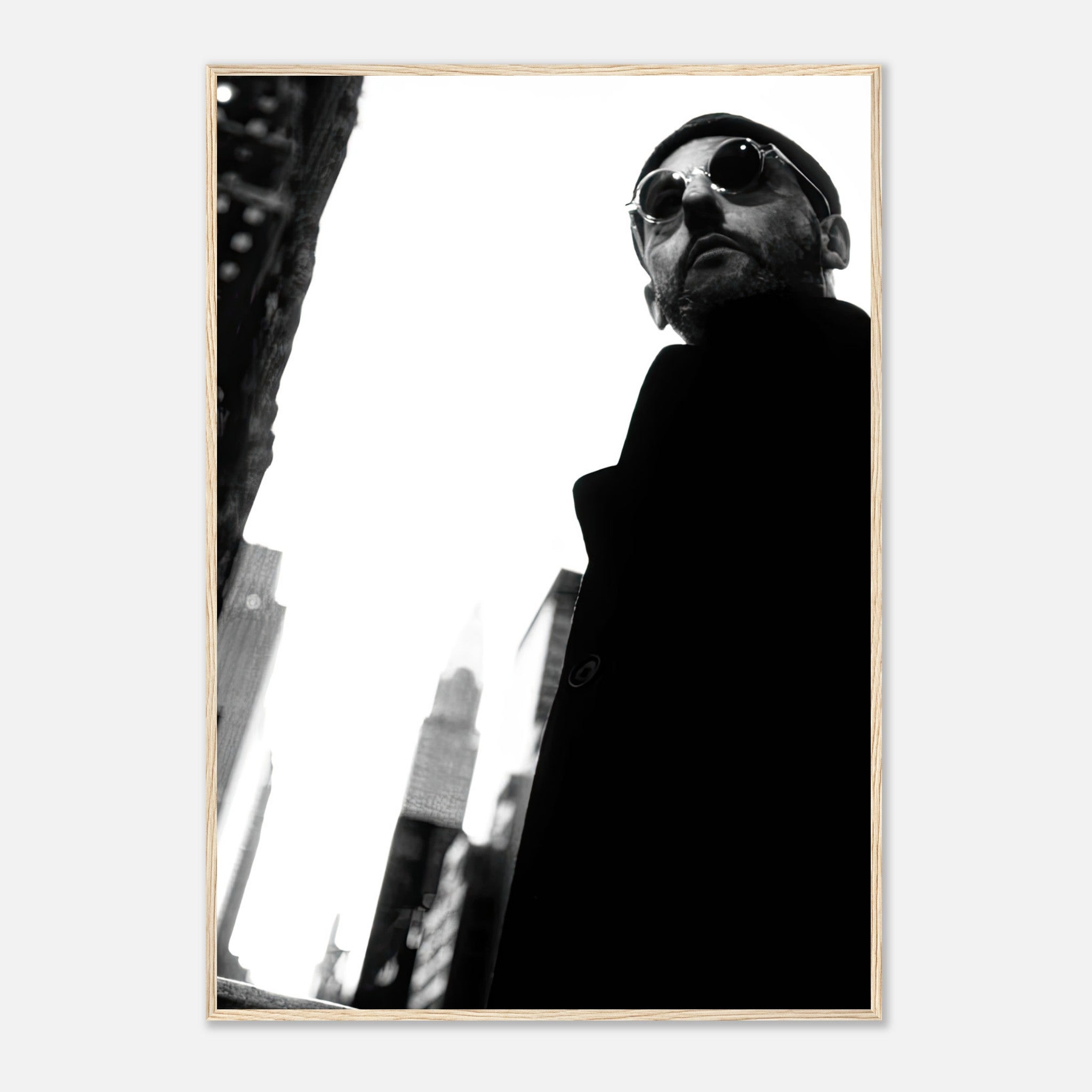 Leon Photography framed print of Jean Reno in urban setting, black-and-white, stylish and cinematic artwork.