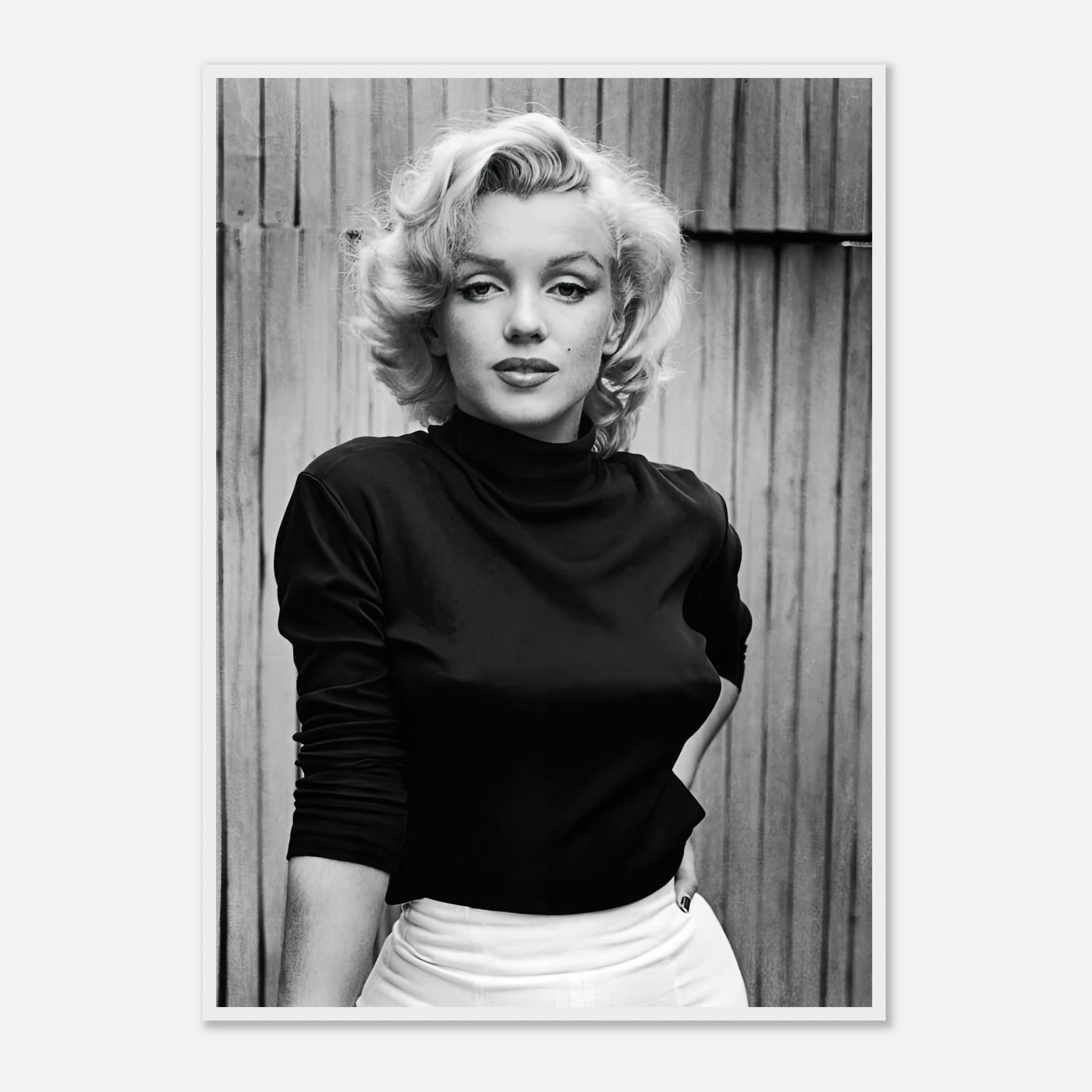 Black-and-white portrait of Marilyn Monroe in a stylish top, exuding Hollywood glamour and timeless elegance.