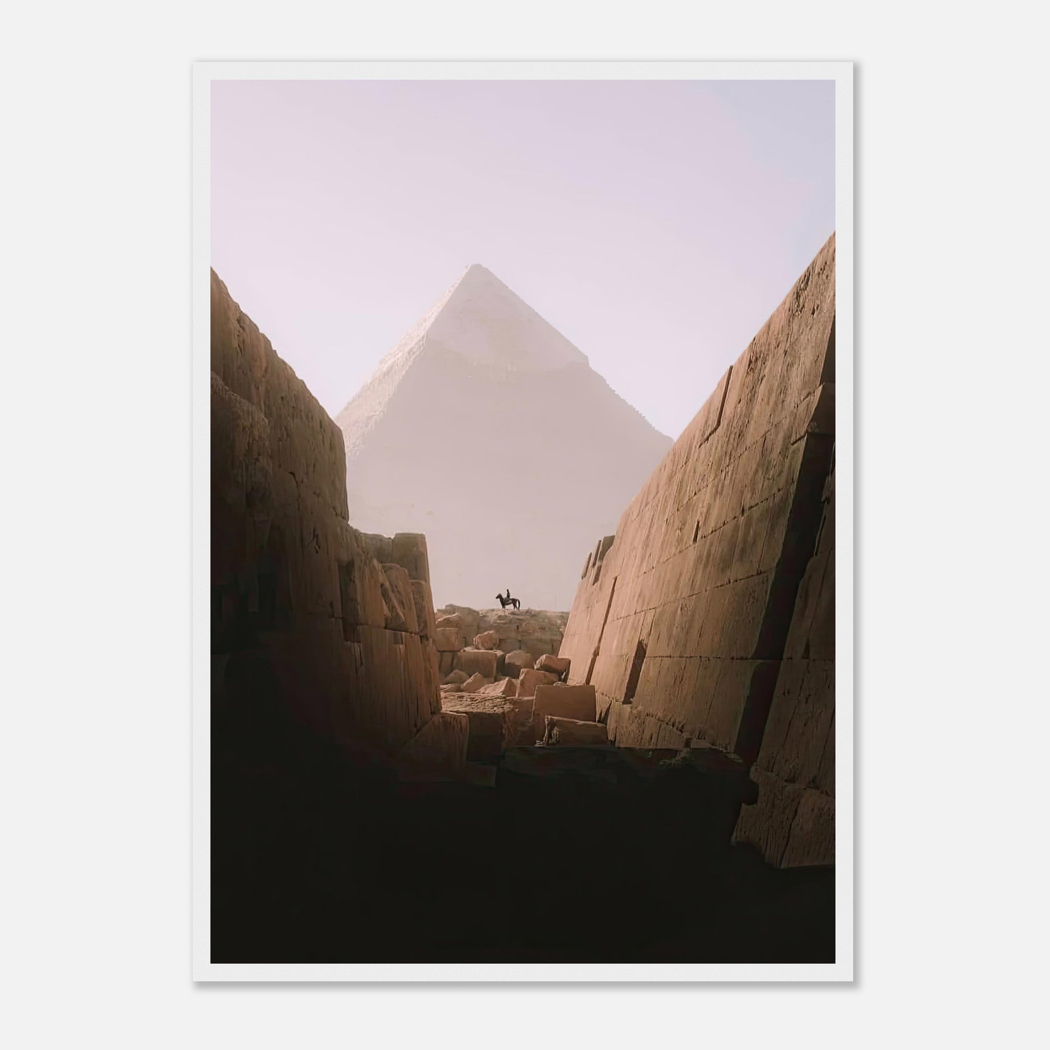 Framed print of a horseback rider silhouetted by the Great Pyramid of Giza framed by ancient stone walls.