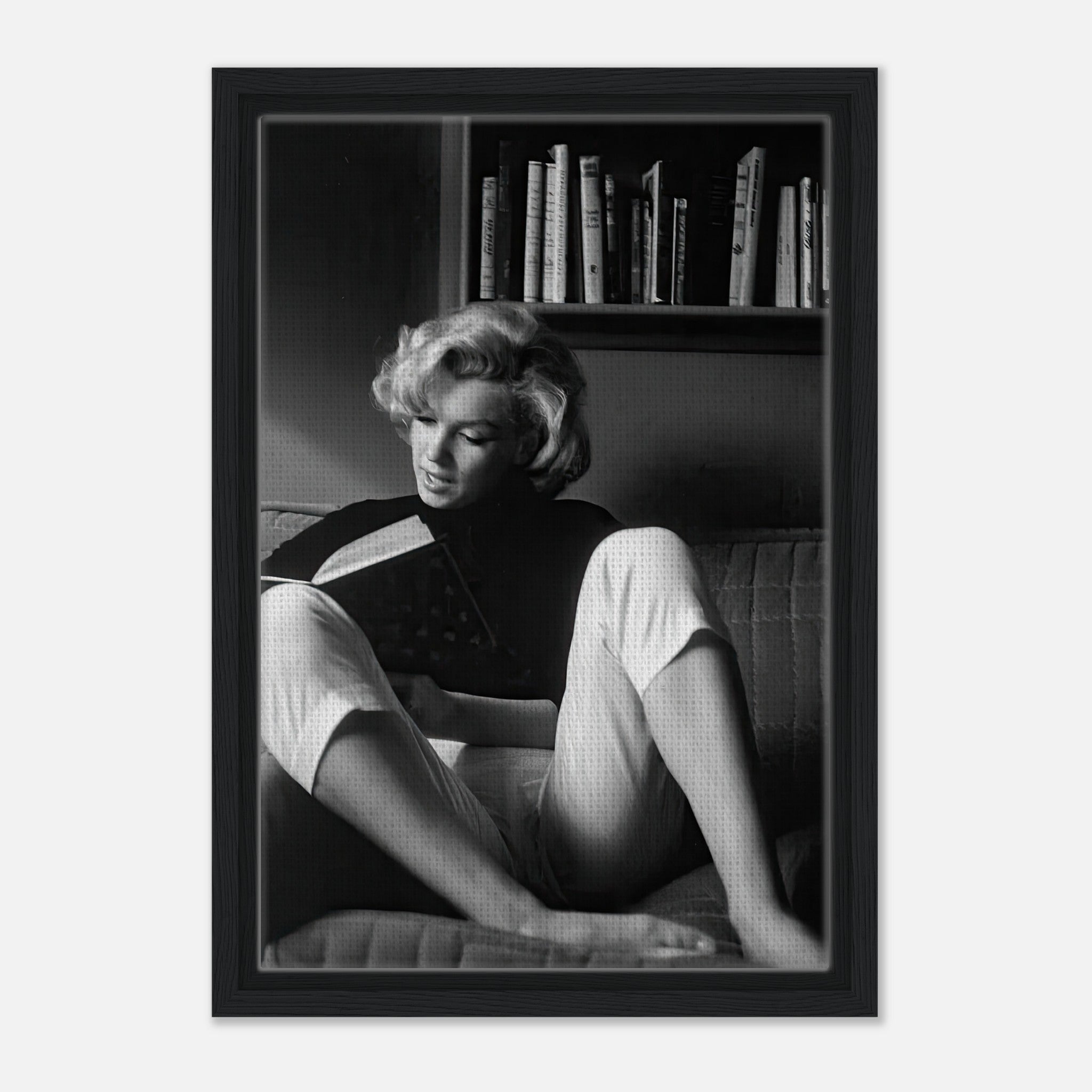 Marilyn Monroe reading at home in a black-and-white framed canvas, showcasing elegance and timeless allure.