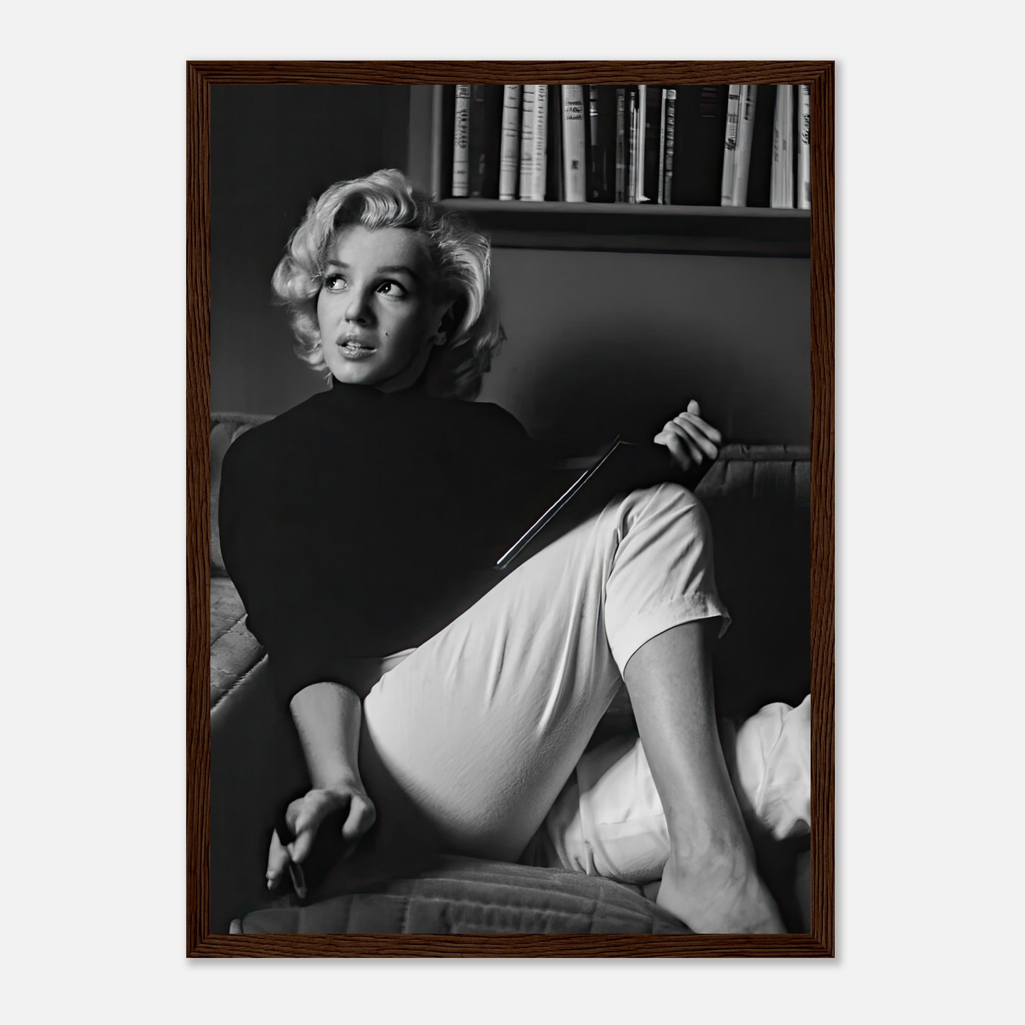 Marilyn Monroe reading a book in a black-and-white framed print, exuding elegance and vintage charm.