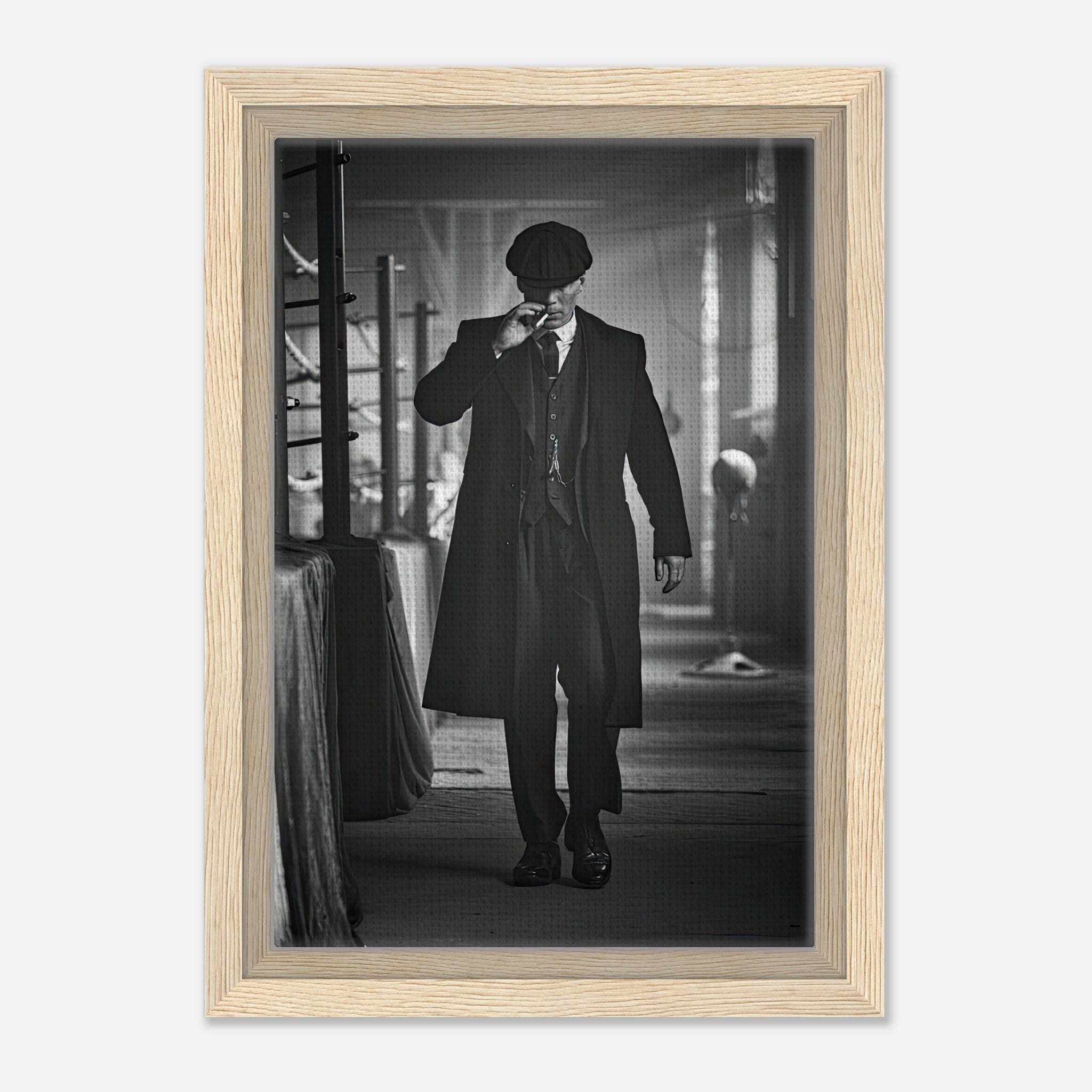 Tommy Shelby Peaky Blinders framed canvas print showcasing a monochromatic image of a man in a long coat and flat cap.
