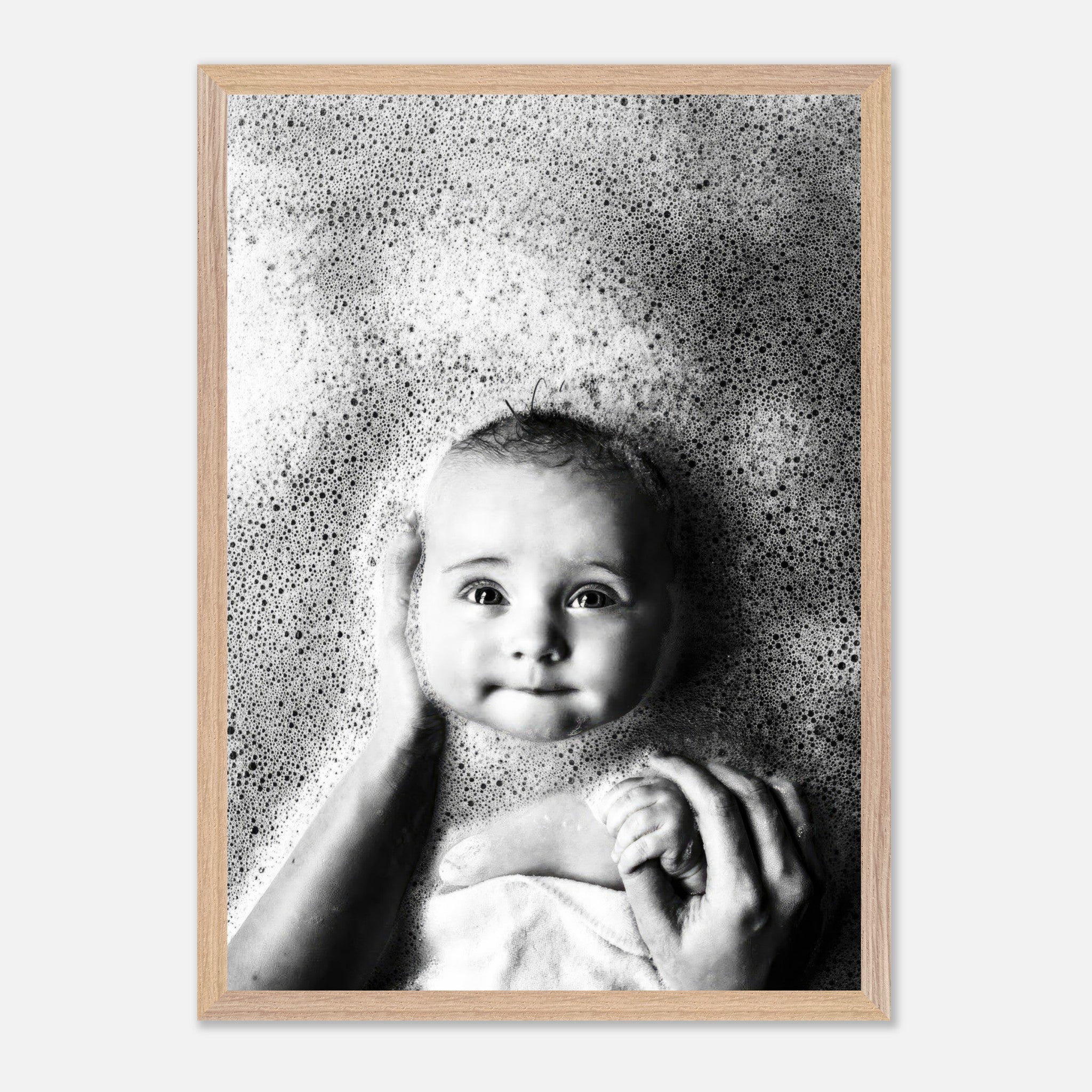 Vintage framed print of a baby smiling in a bubble bath, showcasing childhood innocence in black and white.