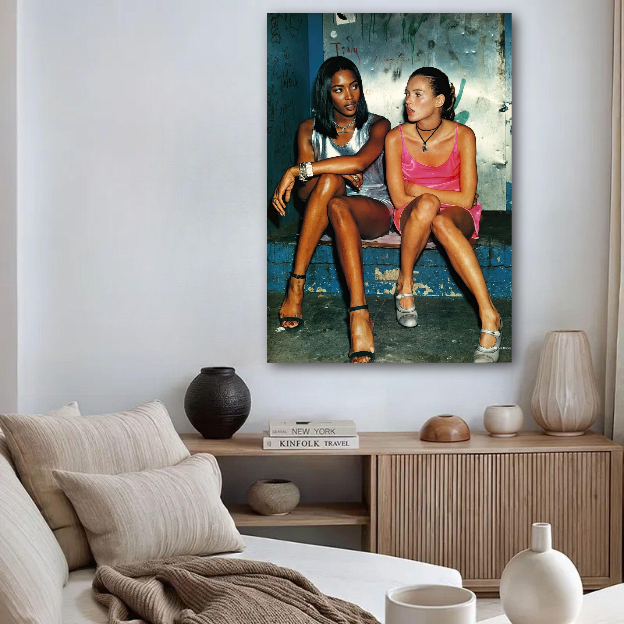 Naomi Campbell and Kate Moss poster showcasing 1990s supermodel glamour in a stylish living room setting.