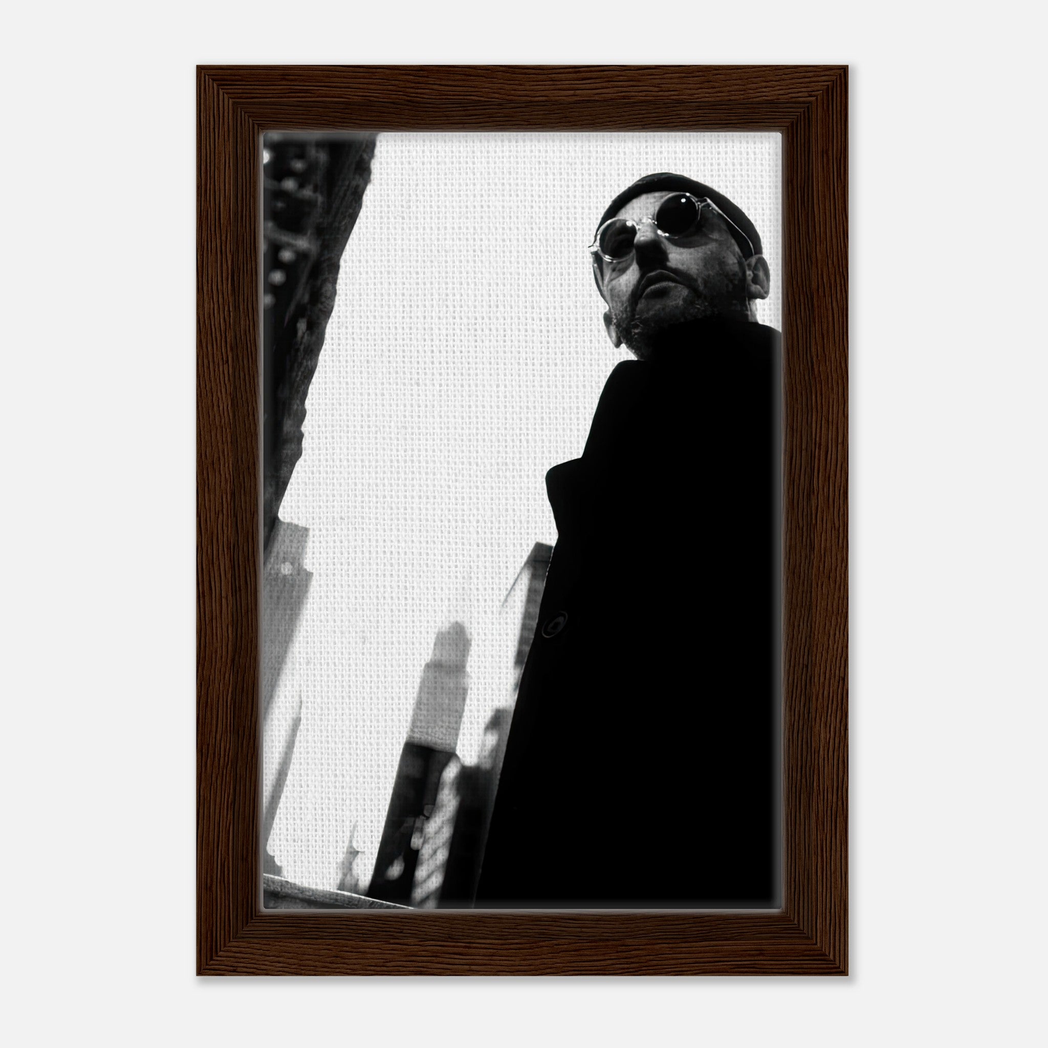 Framed black-and-white canvas print of Jean Reno, showcasing urban elegance and charm.