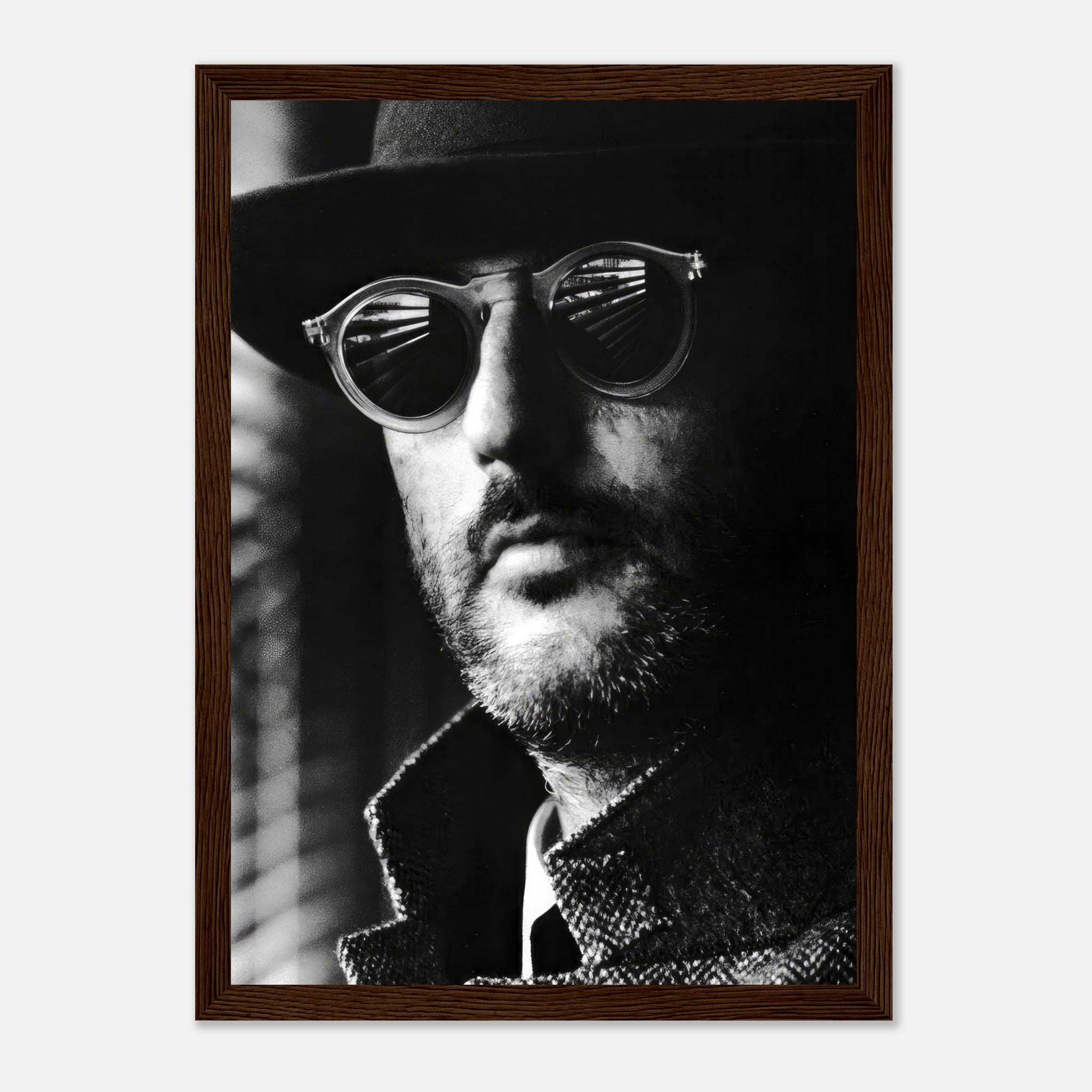 Framed black-and-white print of a man in sunglasses and hat, evoking mystery and cinematic charm.