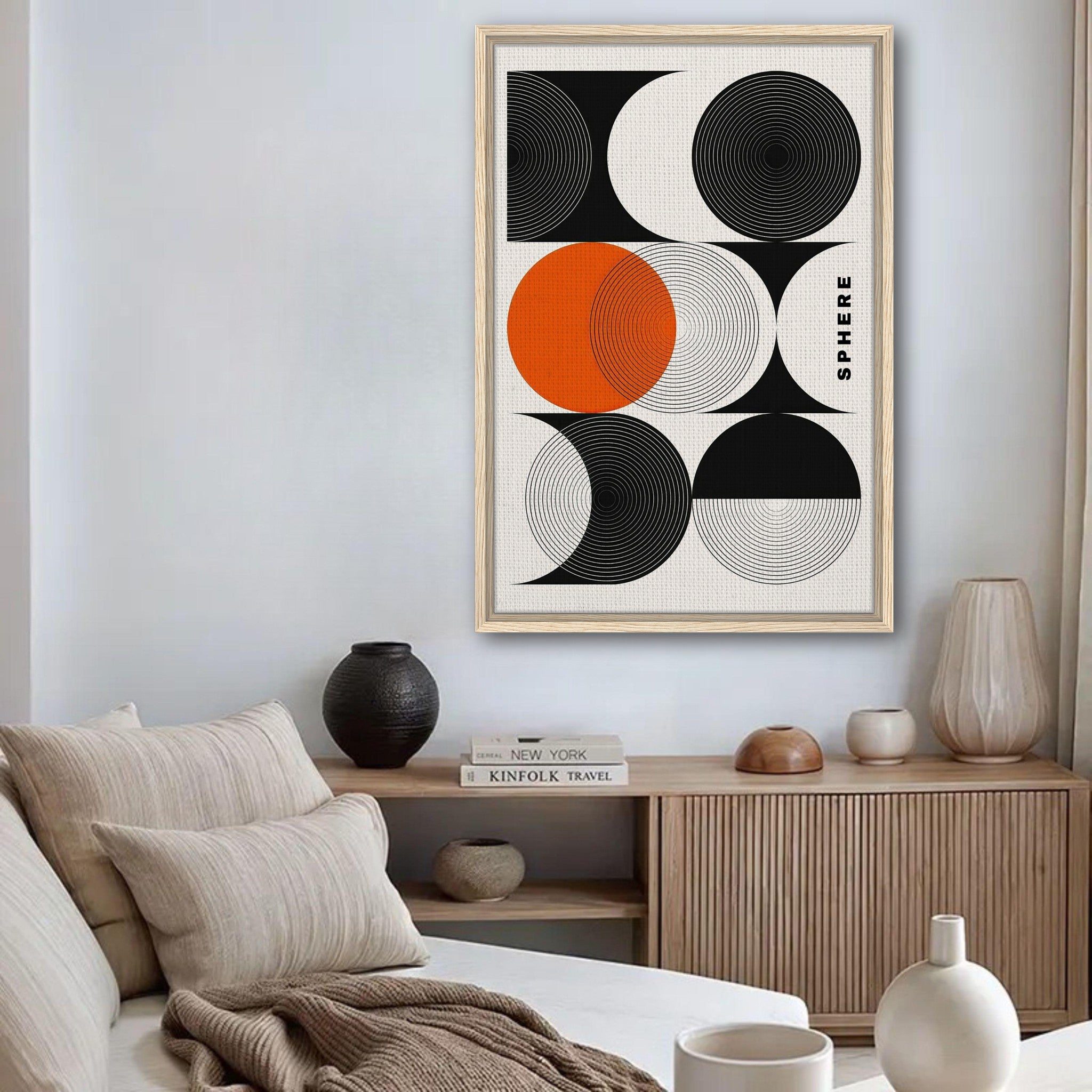 Abstract geometric sphere art framed canvas print in stylish room decor with black, white, and orange colors.