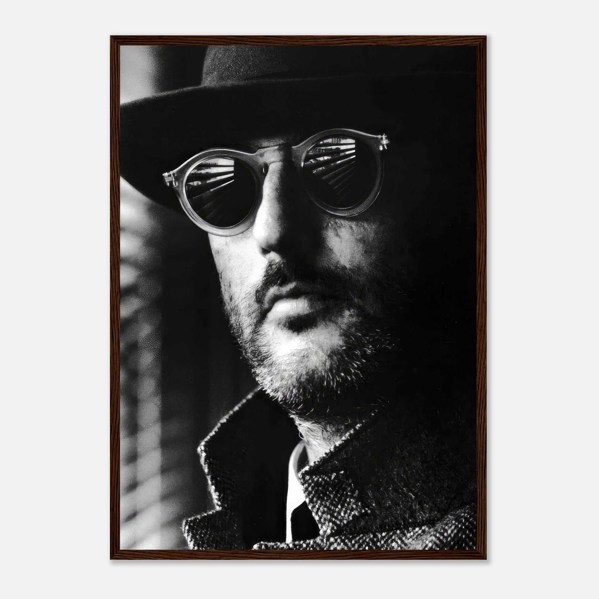 Jean Reno black-and-white photography print featuring a man in sunglasses and a hat, framed for elegance and sophistication.