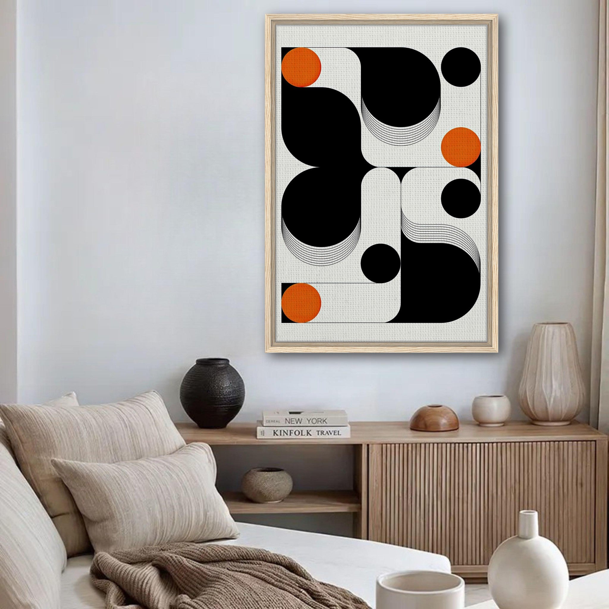 Modern geometric abstract art framed canvas print with black, white, and orange colors in a stylish living room.