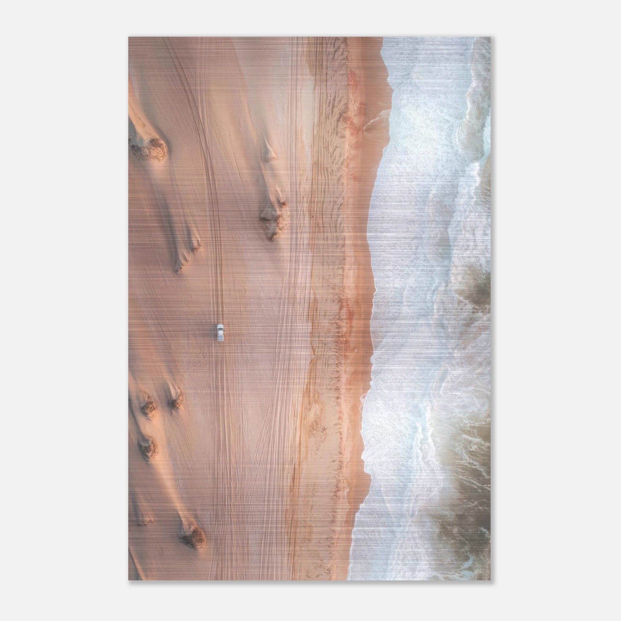 Aerial drone photograph of golden desert dunes meeting ocean waves on brushed metal print.