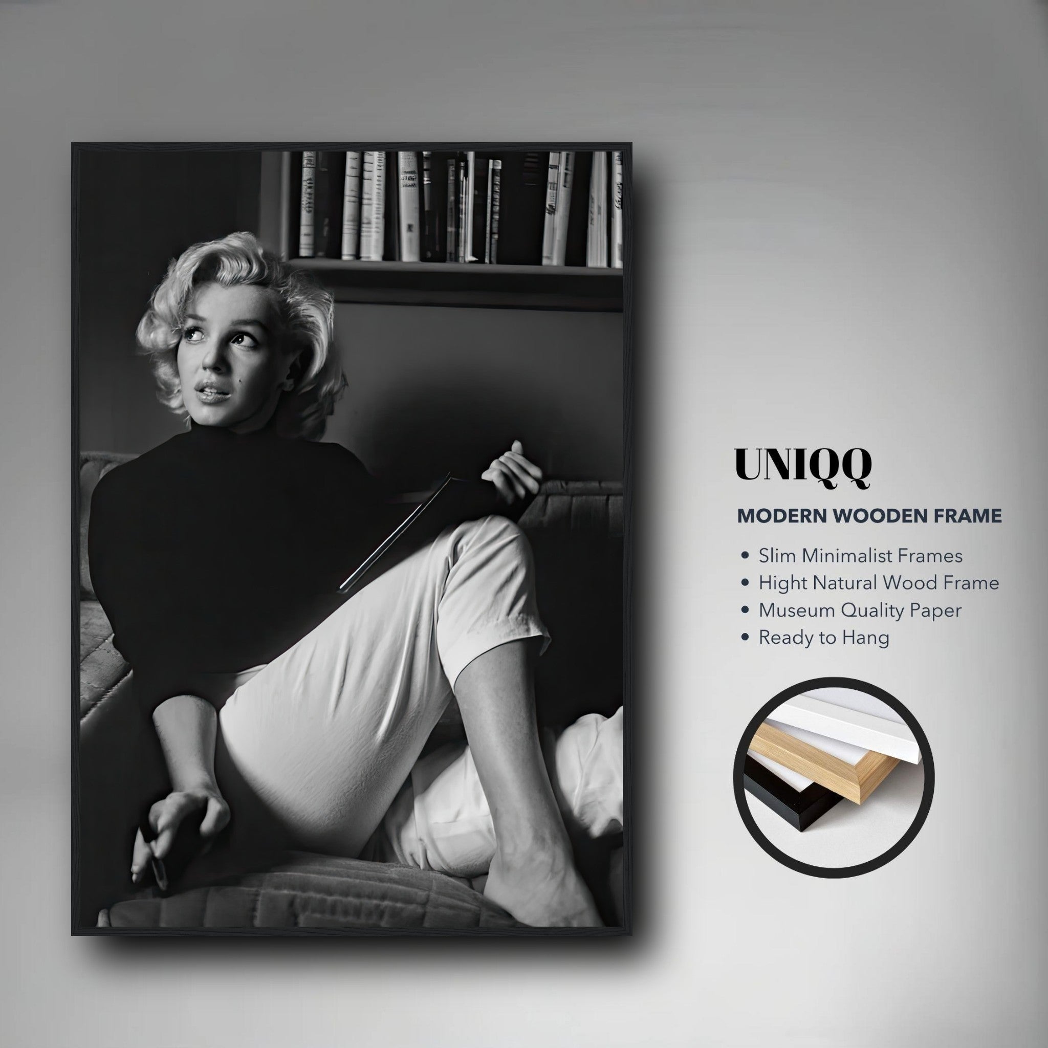 Marilyn Monroe reading a book in a framed black-and-white print, showcasing vintage Hollywood charm.