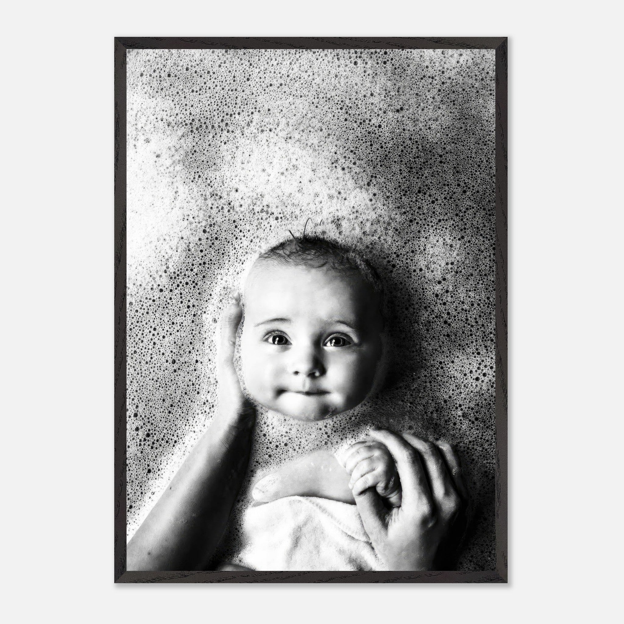 Black-and-white fine art print of a baby in a bubble bath, capturing innocence and joy in childhood.