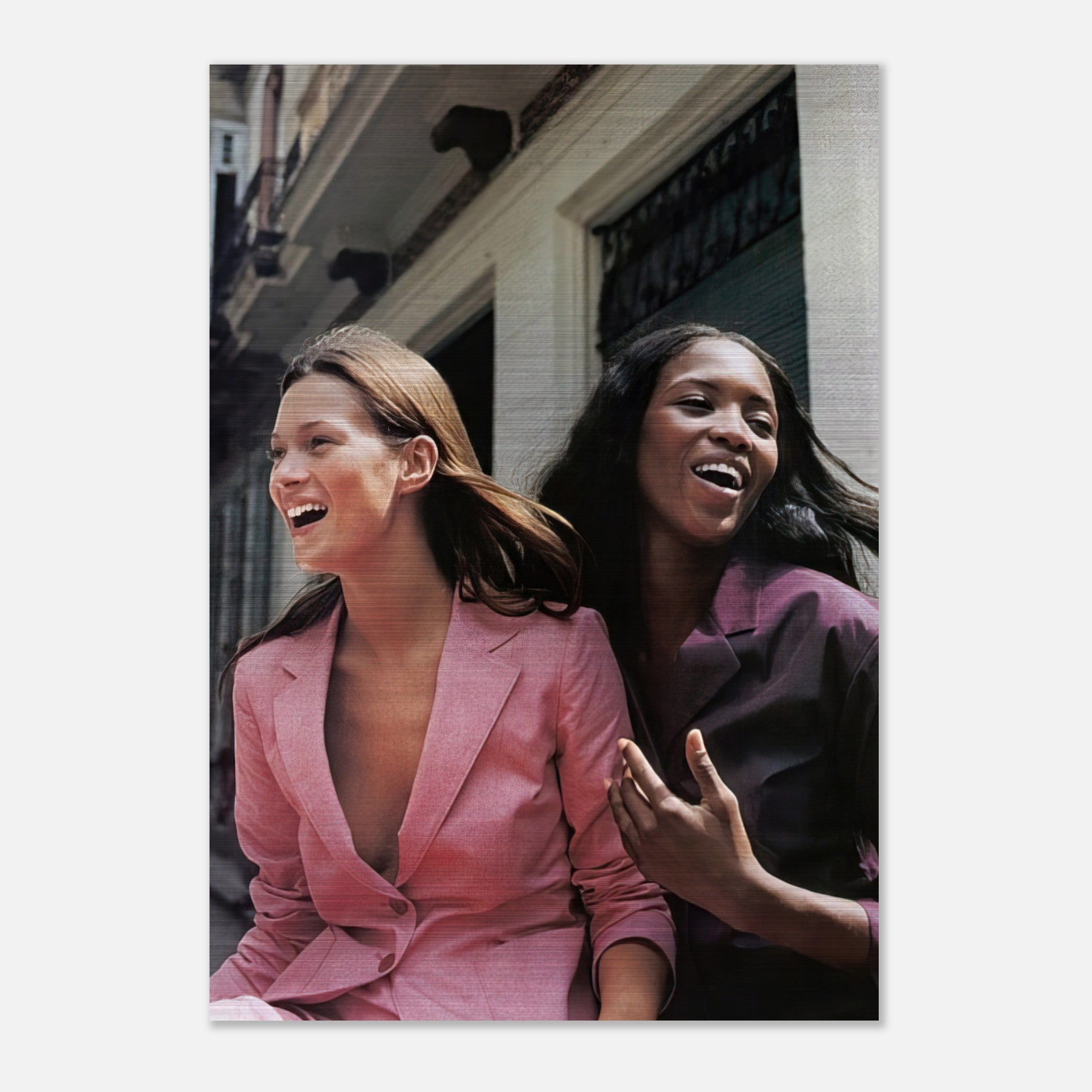 Naomi Campbell and Kate Moss enjoying a joyful moment, captured in elegant brushed metal print.
