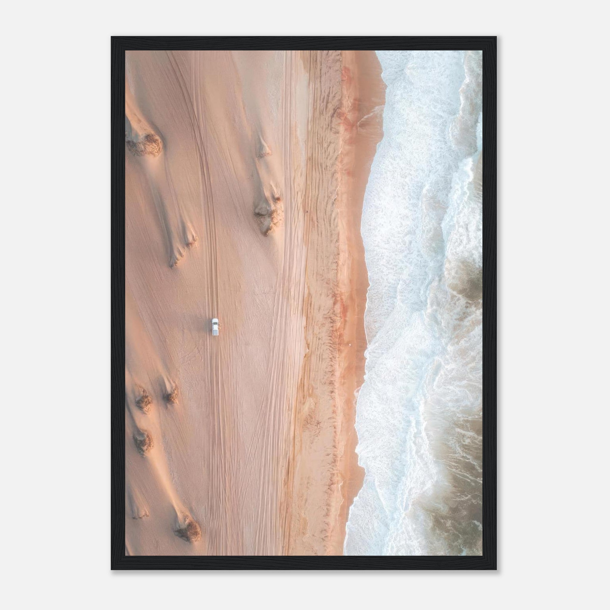 Stunning aerial drone photography print of desert sand meeting ocean waves, framed for elegant decor.