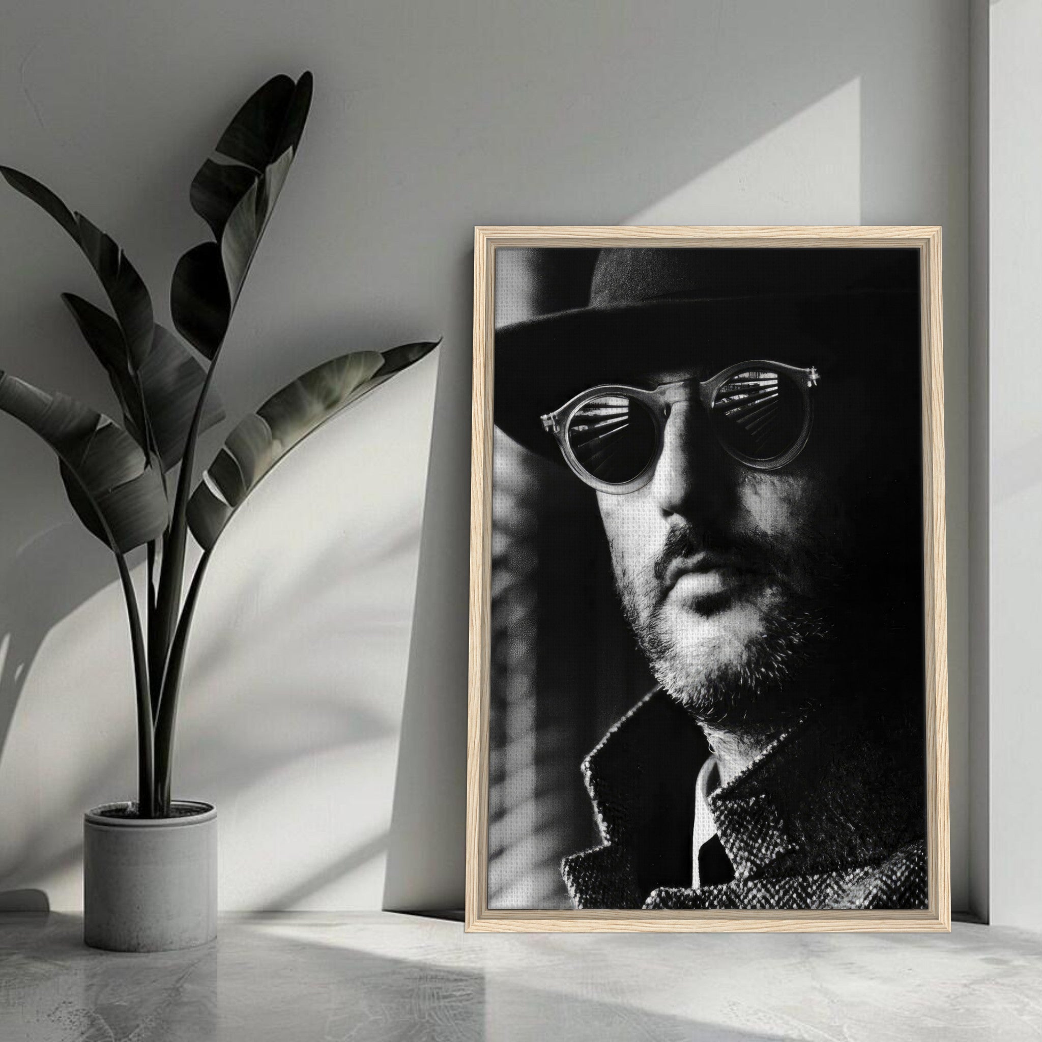 Jean Reno Leon black-and-white portrait in a modern setting with sleek design and premium wood-grain frame.