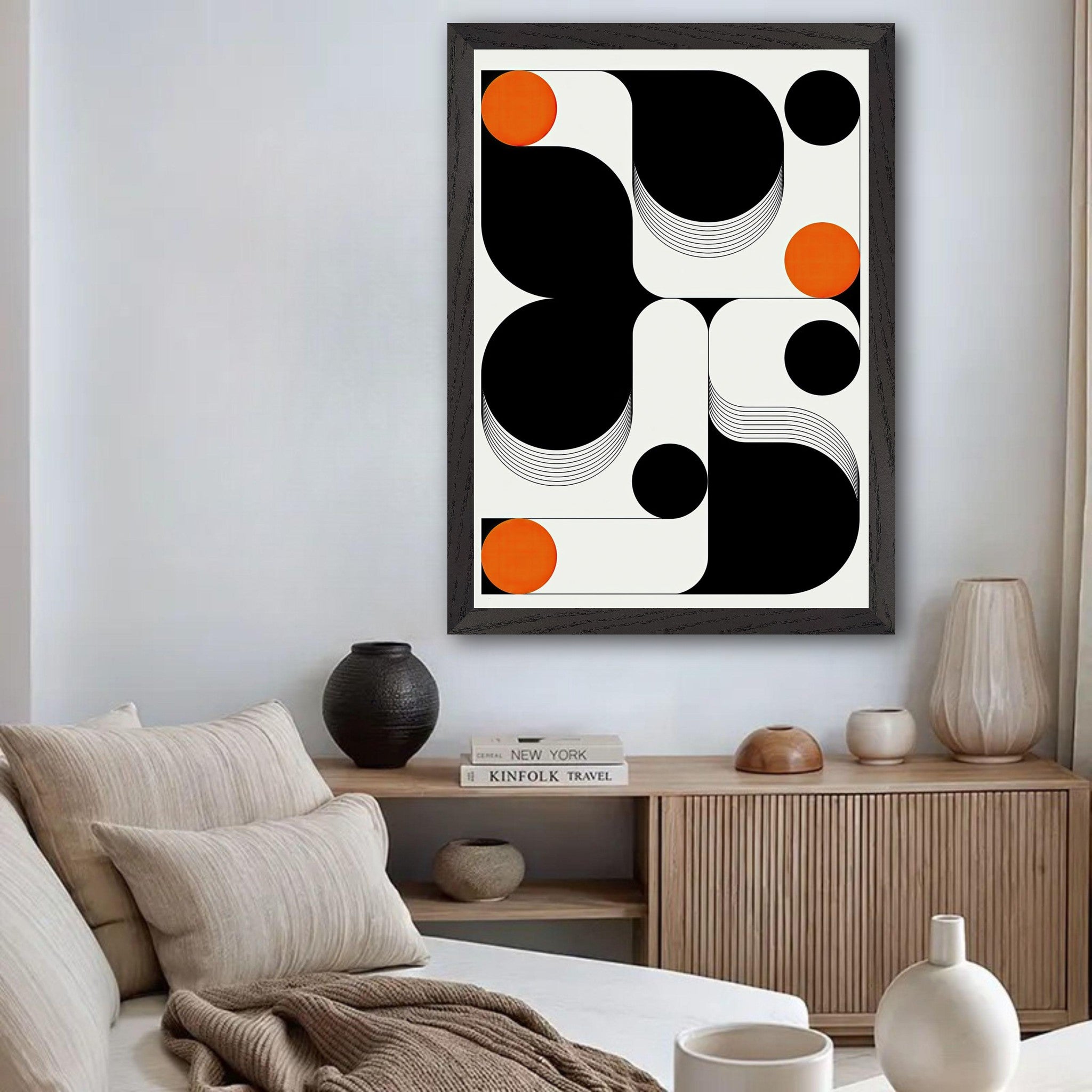 Modern geometric abstract art framed print featuring bold black and white shapes with vibrant orange accents.