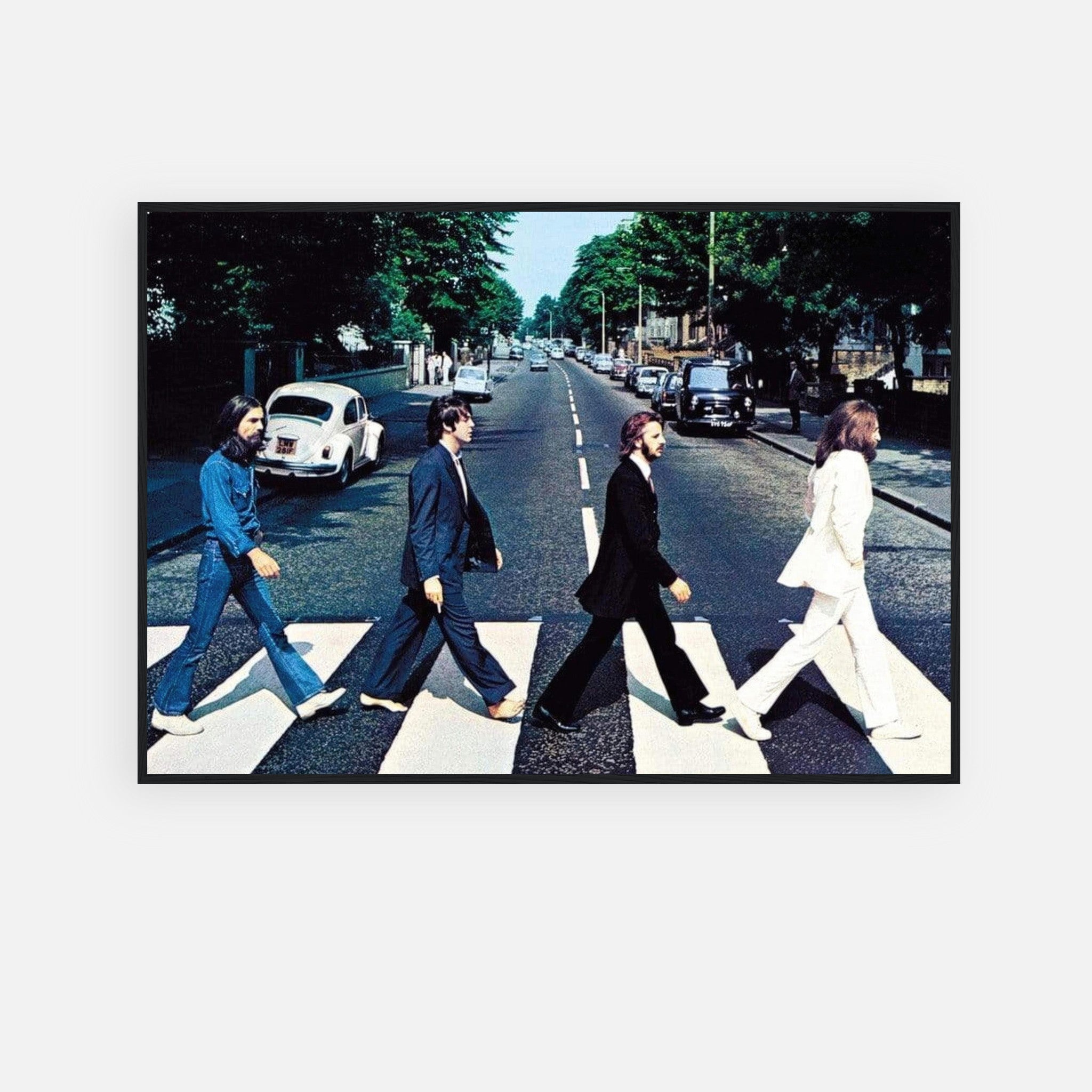 The Beatles Abbey Road framed print featuring iconic album cover art of four members walking on zebra crossing.