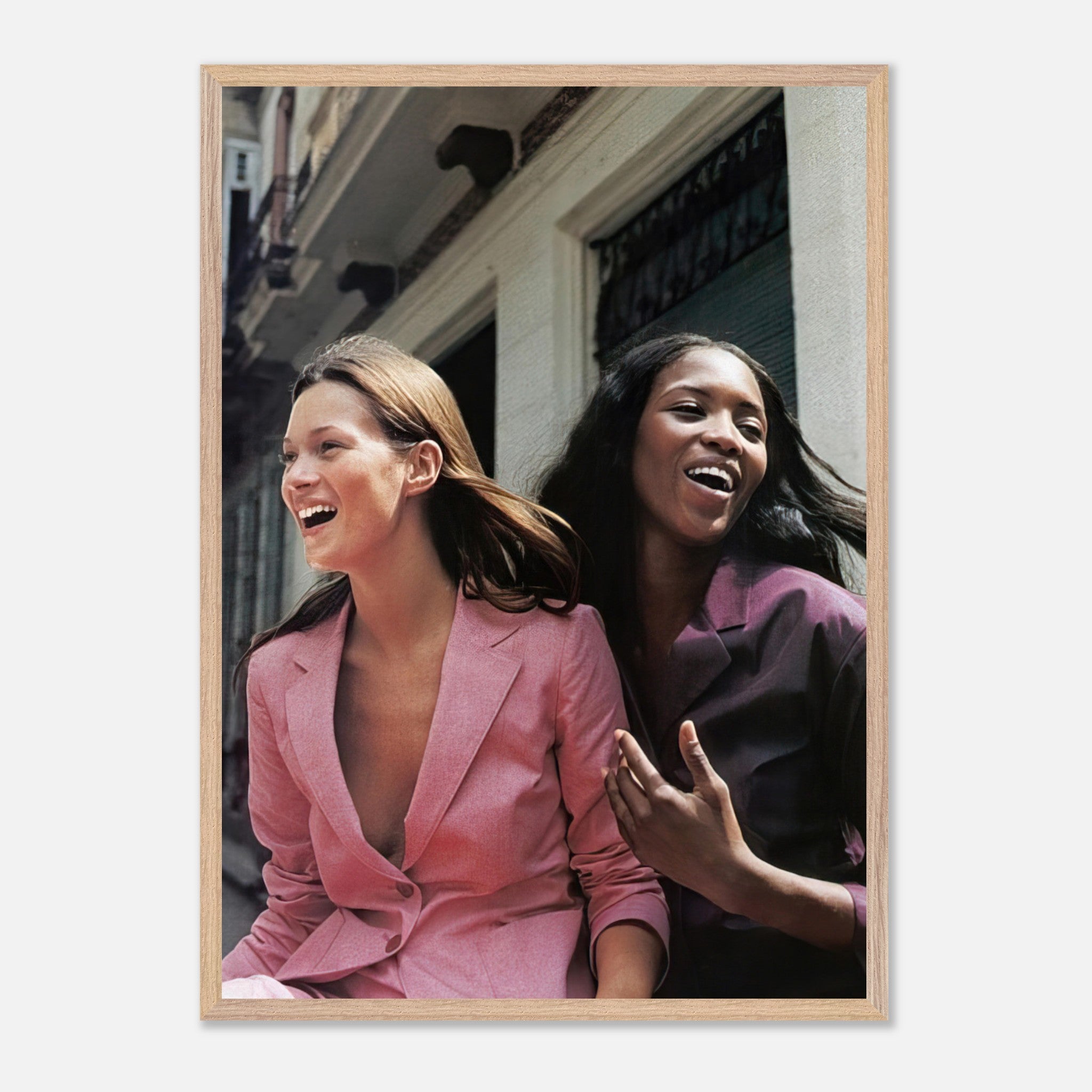 Vintage framed print of supermodels Naomi Campbell and Kate Moss enjoying a candid moment, showcasing timeless elegance.