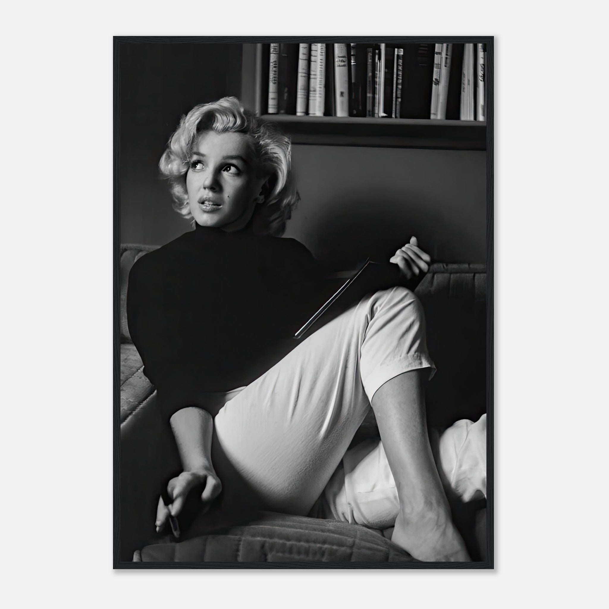 Marilyn Monroe reading a book in black-and-white framed print, perfect for adding vintage elegance to any space.