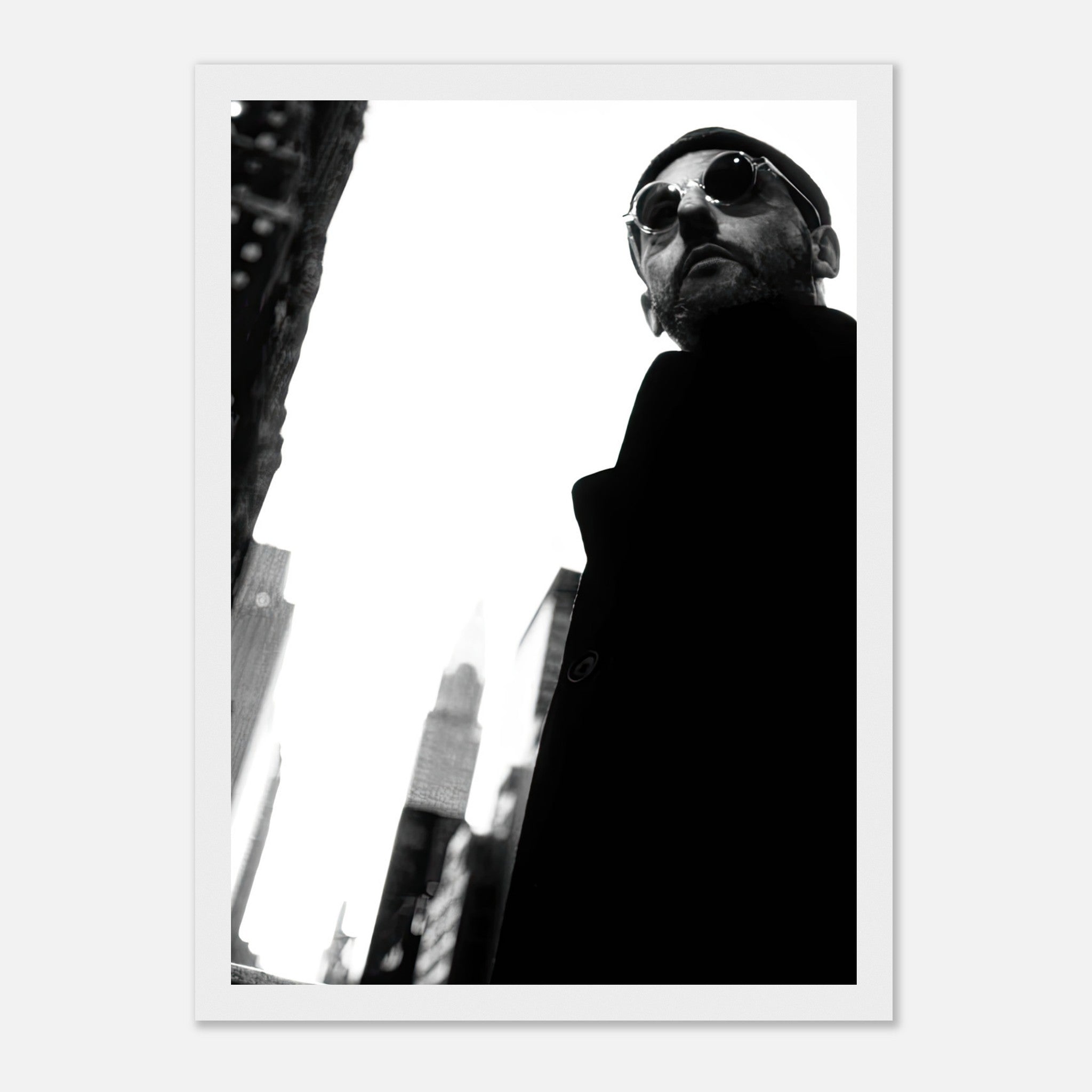 Leon Photography Jean Reno framed print in black-and-white, showcasing urban elegance and cinematic style.