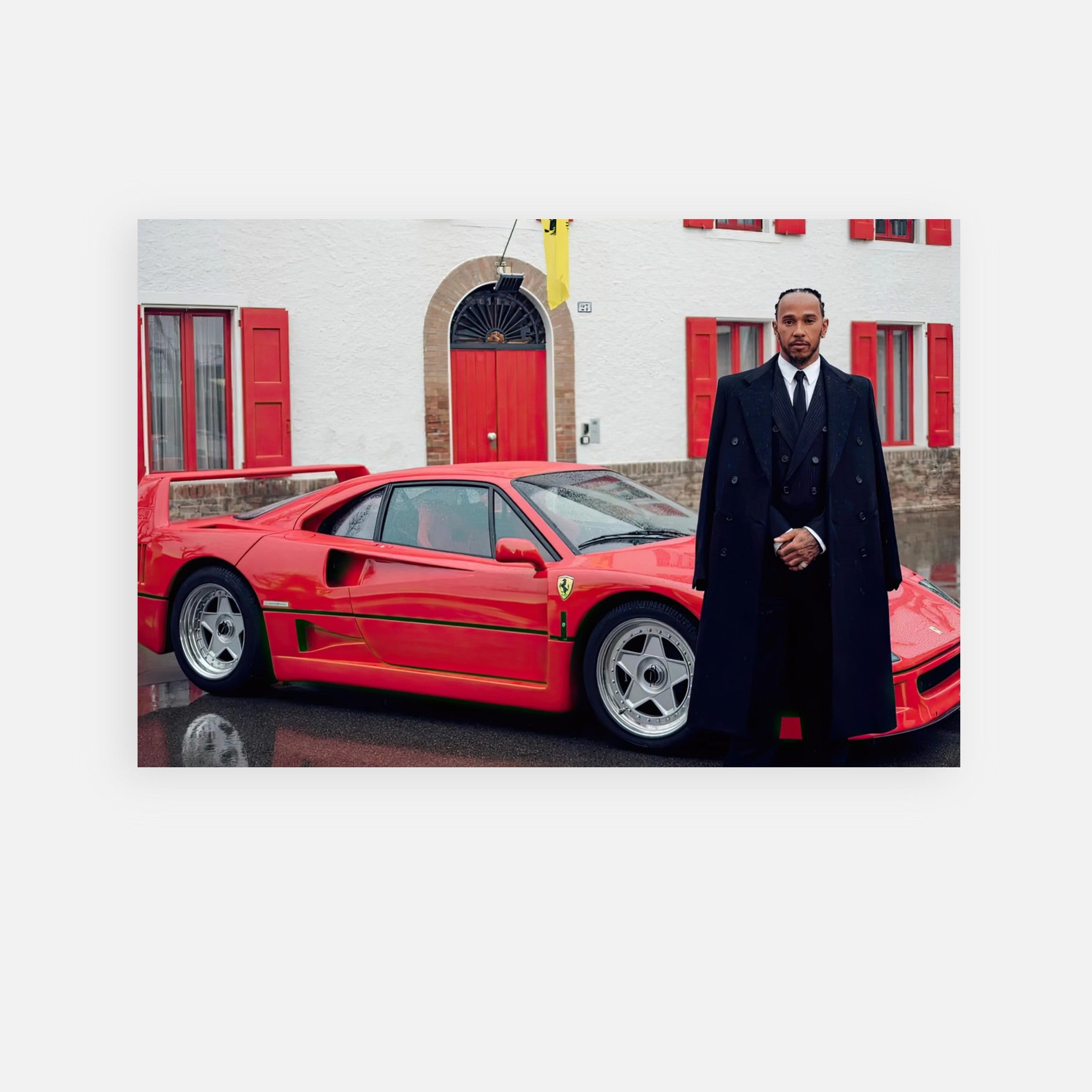 Lewis Hamilton standing beside a Ferrari F40 at Enzo Ferrari's house, captured in a premium metal print.