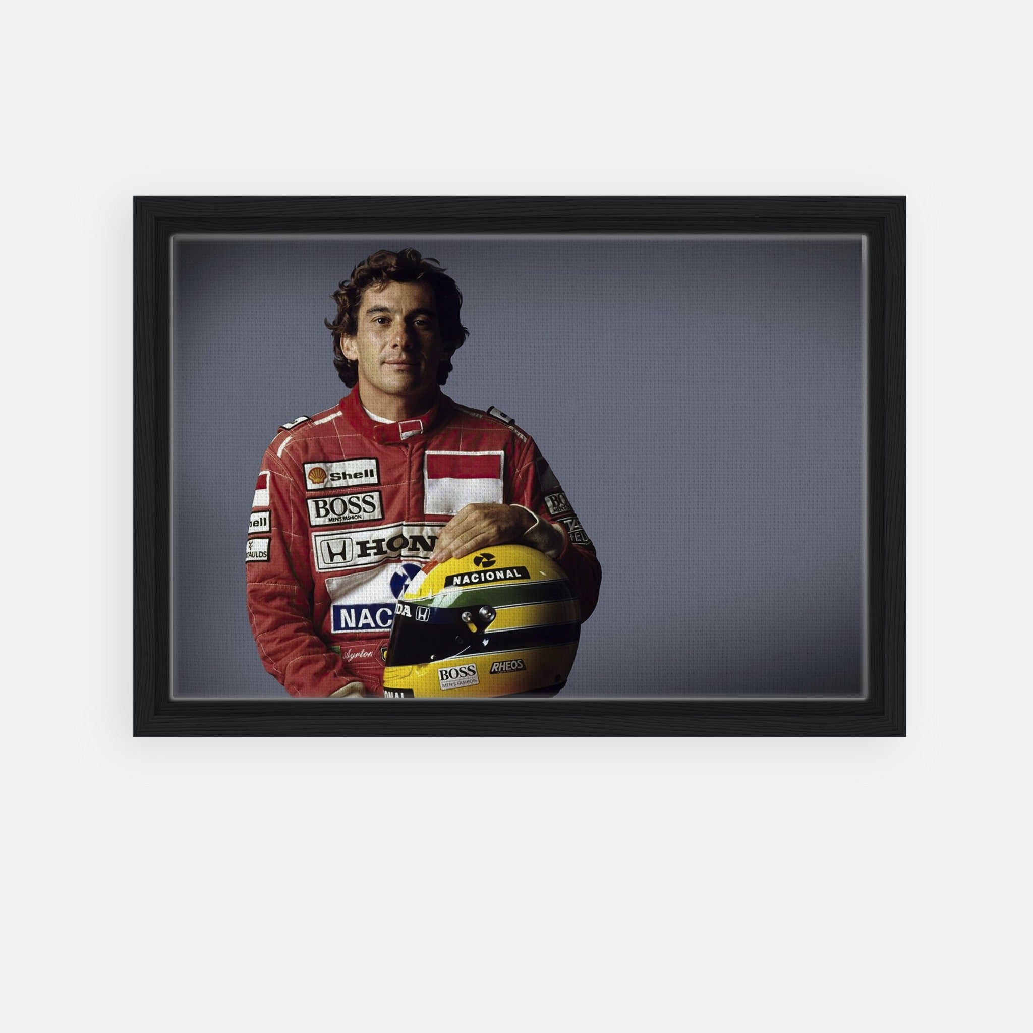 Ayrton Senna framed canvas print showcasing the legendary F1 driver in a red racing suit, holding his helmet.