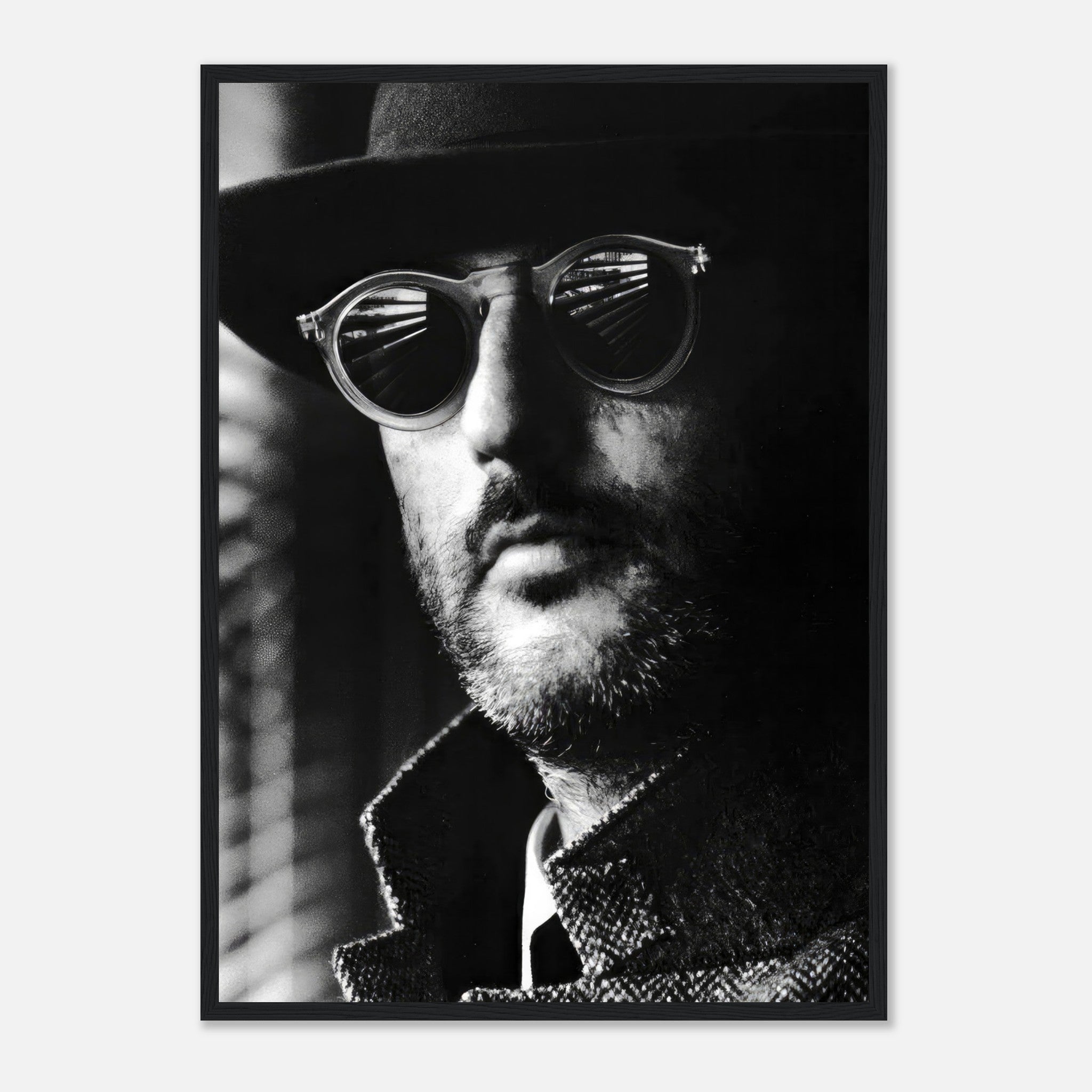 Framed black-and-white print of a man in sunglasses and a hat, exuding cinematic charm and sophistication.