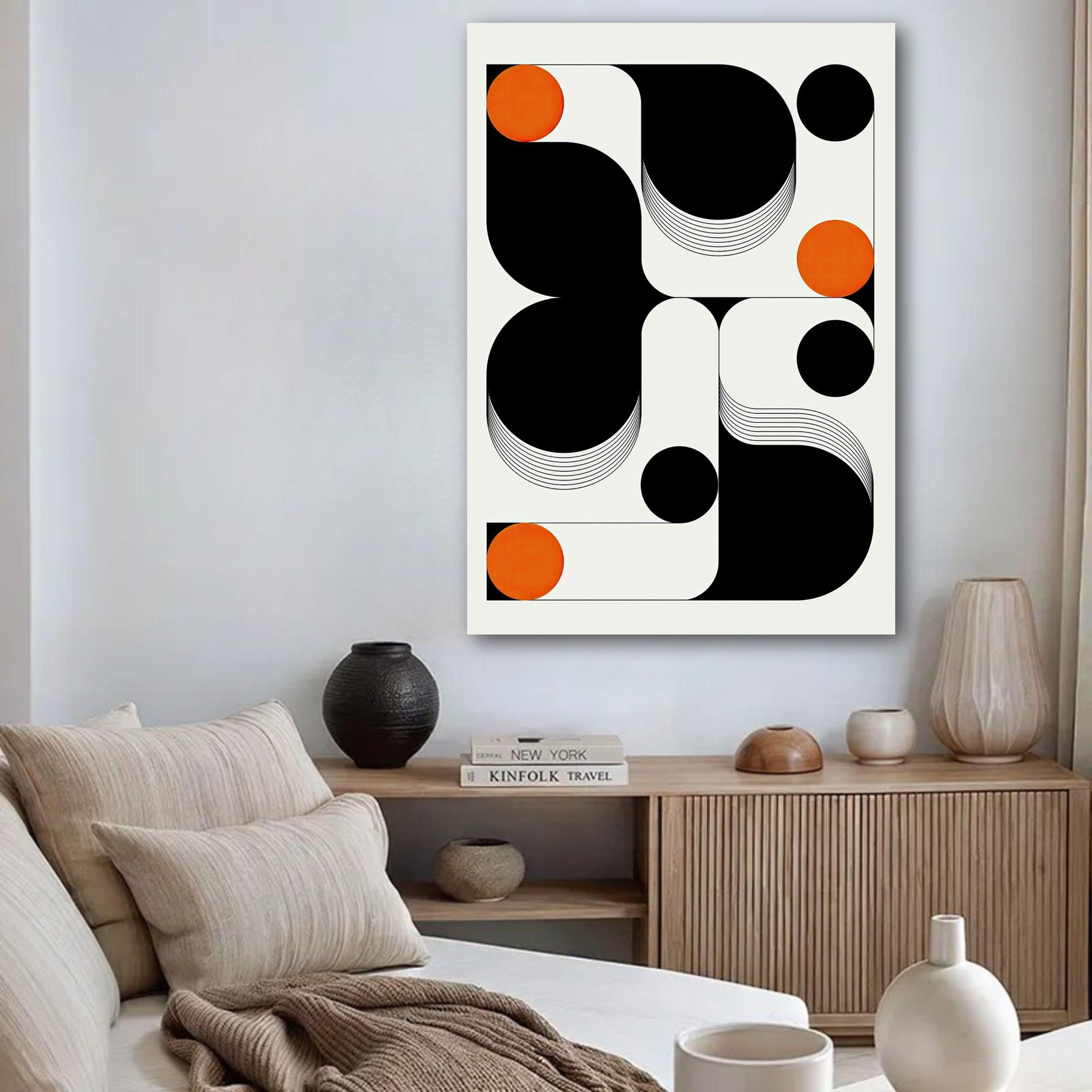 Modern geometric abstract art poster featuring black, white, and vibrant orange shapes in a stylish living room setting.