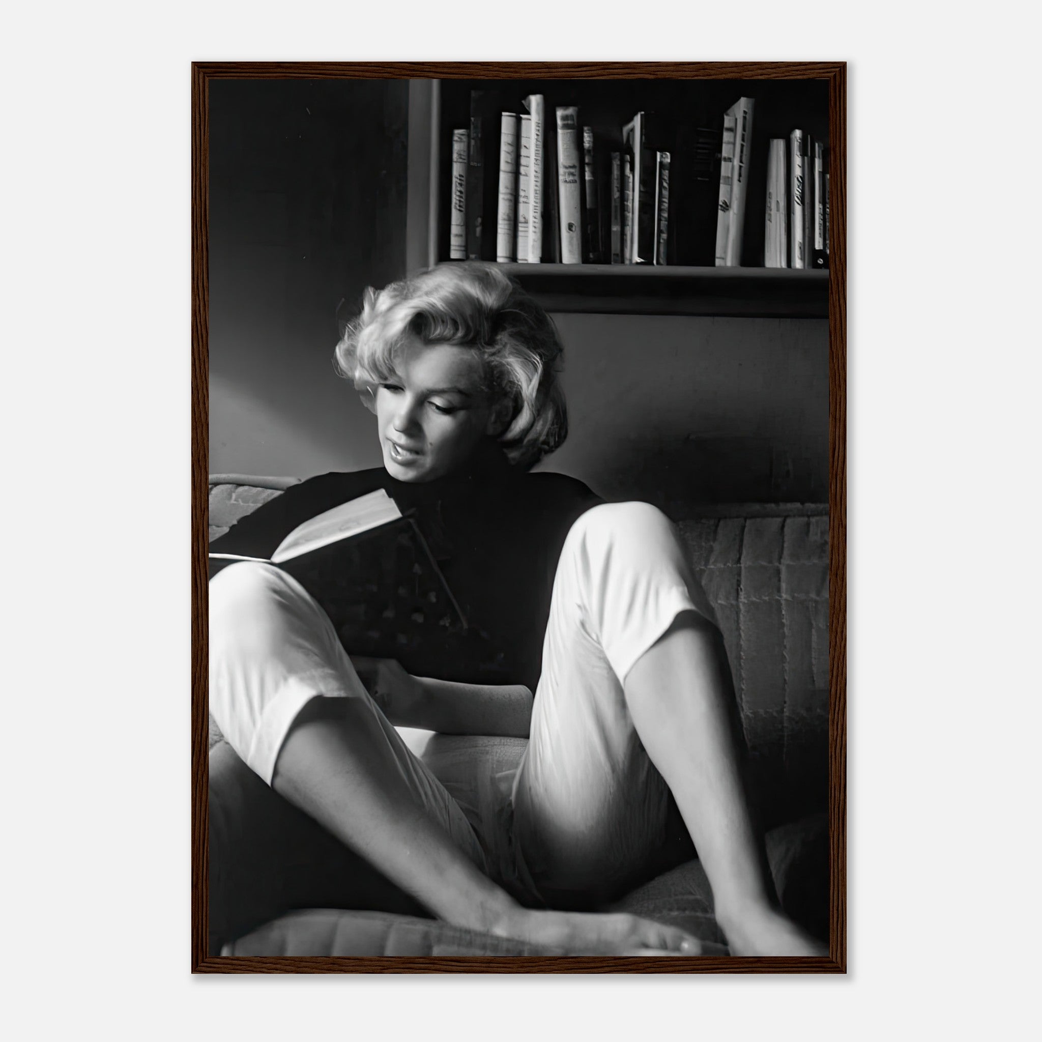 Marilyn Monroe reading at home, black-and-white framed print showcasing classic Hollywood elegance.