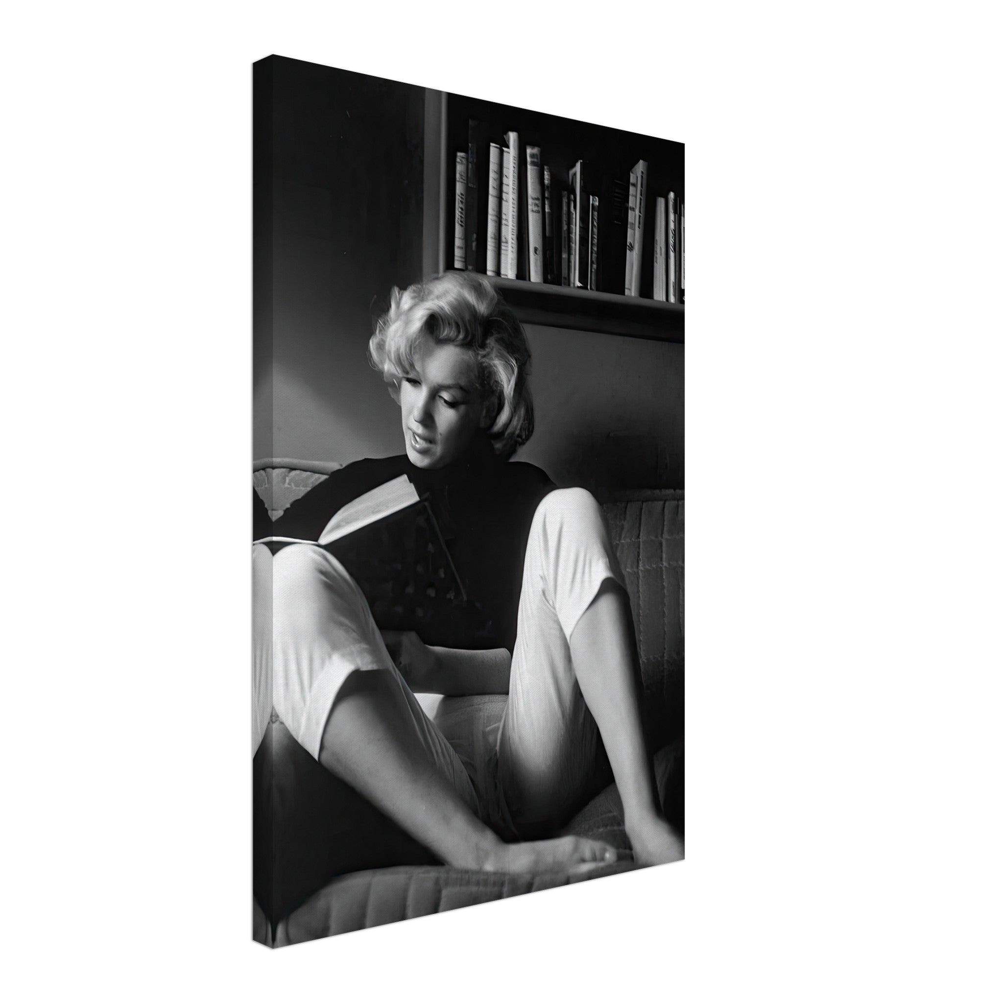 Marilyn Monroe reading at home, captured in timeless black-and-white elegance, showcasing Hollywood glamour.