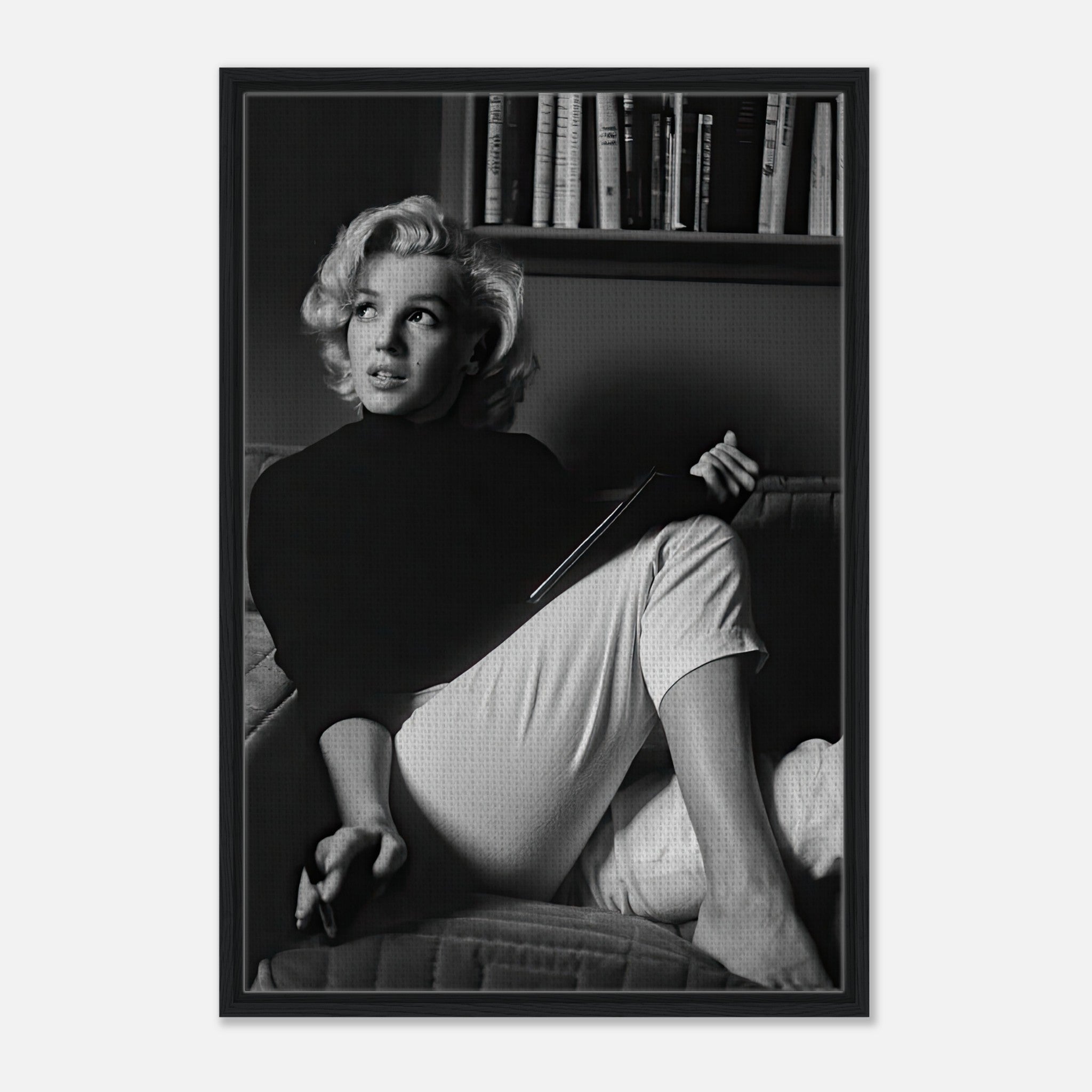 Marilyn Monroe reading a book in black-and-white framed canvas print, exuding elegance and charm.