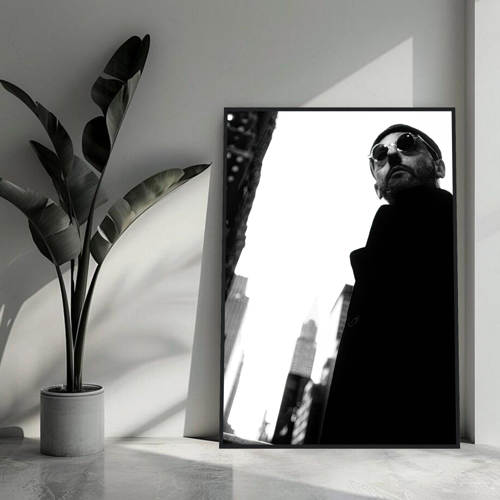 Black-and-white framed print of Jean Reno in urban setting, showcasing timeless cinematic style.