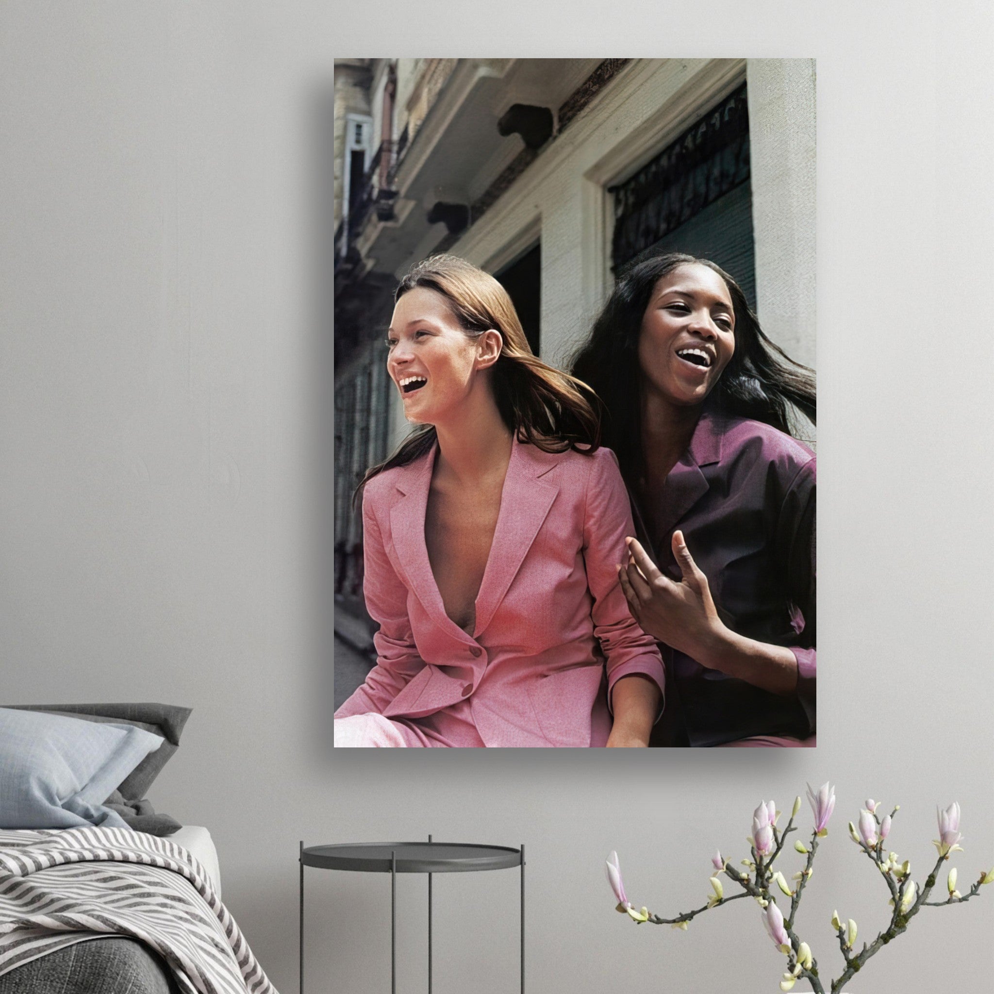 Naomi Campbell x Kate Moss poster featuring iconic models in stylish outfits and joyful expressions.