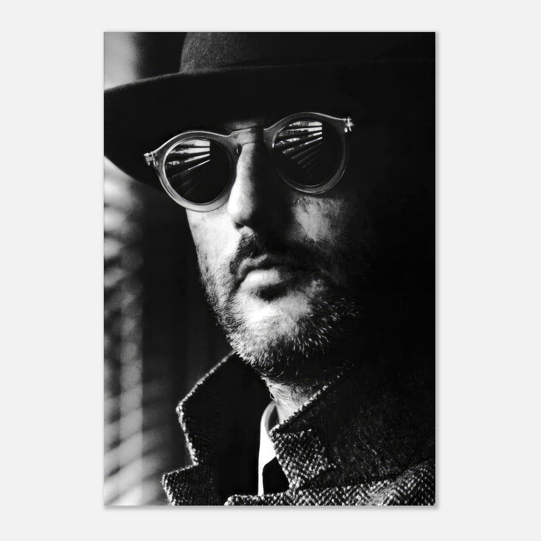 Black-and-white poster of Jean Reno as Leon, showcasing his iconic sunglasses and mysterious expression.