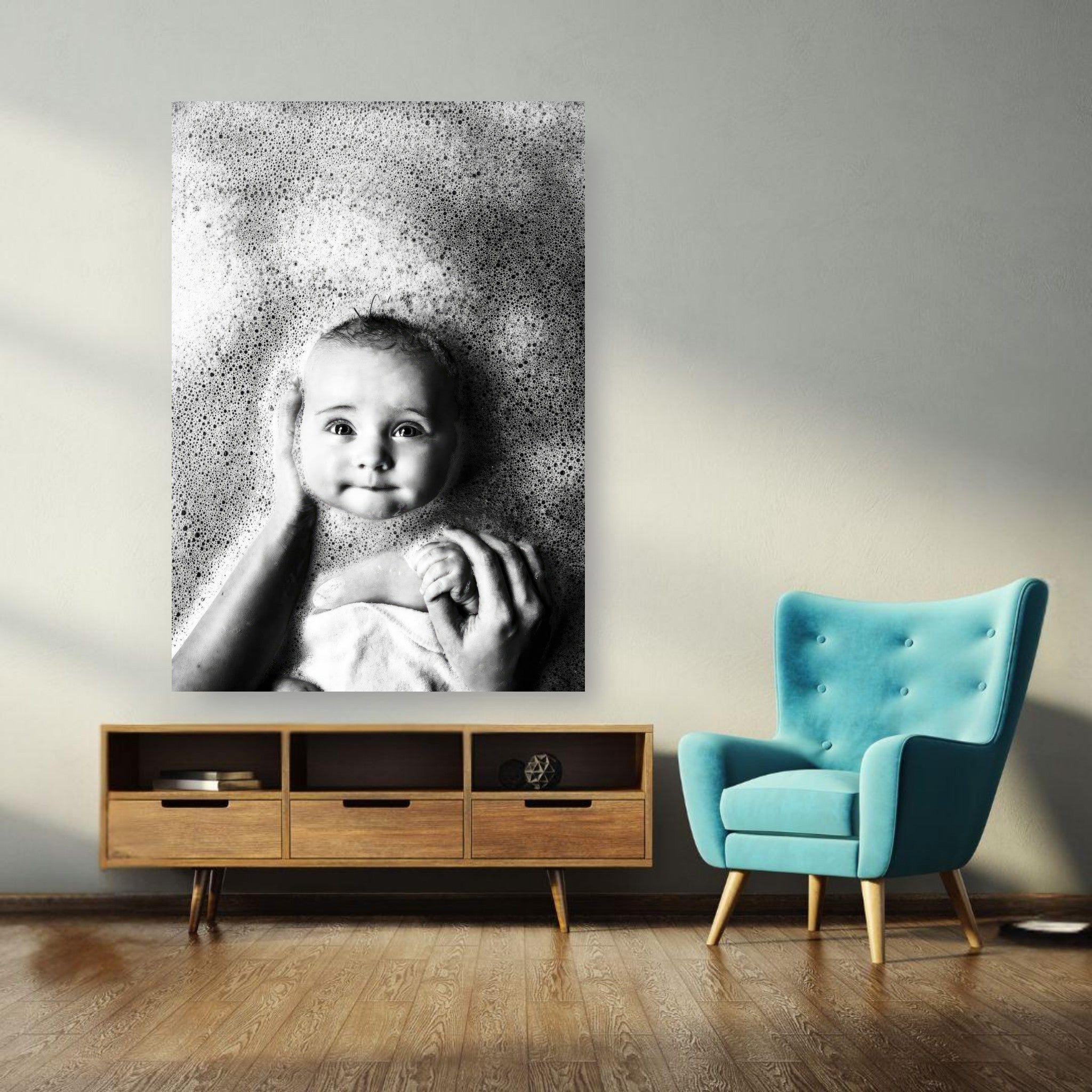Black and white poster of a smiling baby in a bubble bath, adding warmth to a modern living room decor.