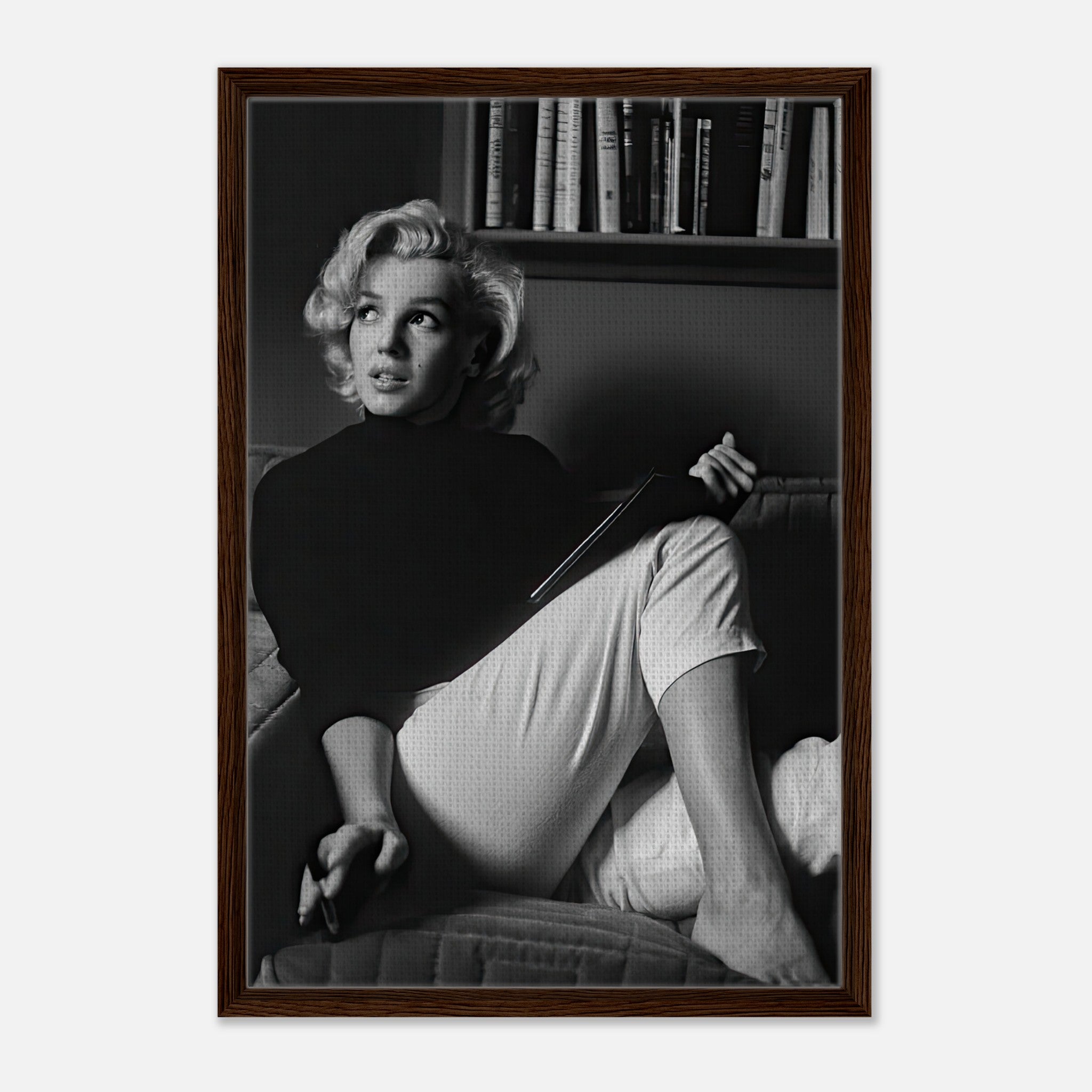 Marilyn Monroe reading in black-and-white framed canvas print, showcasing elegance and sophistication.