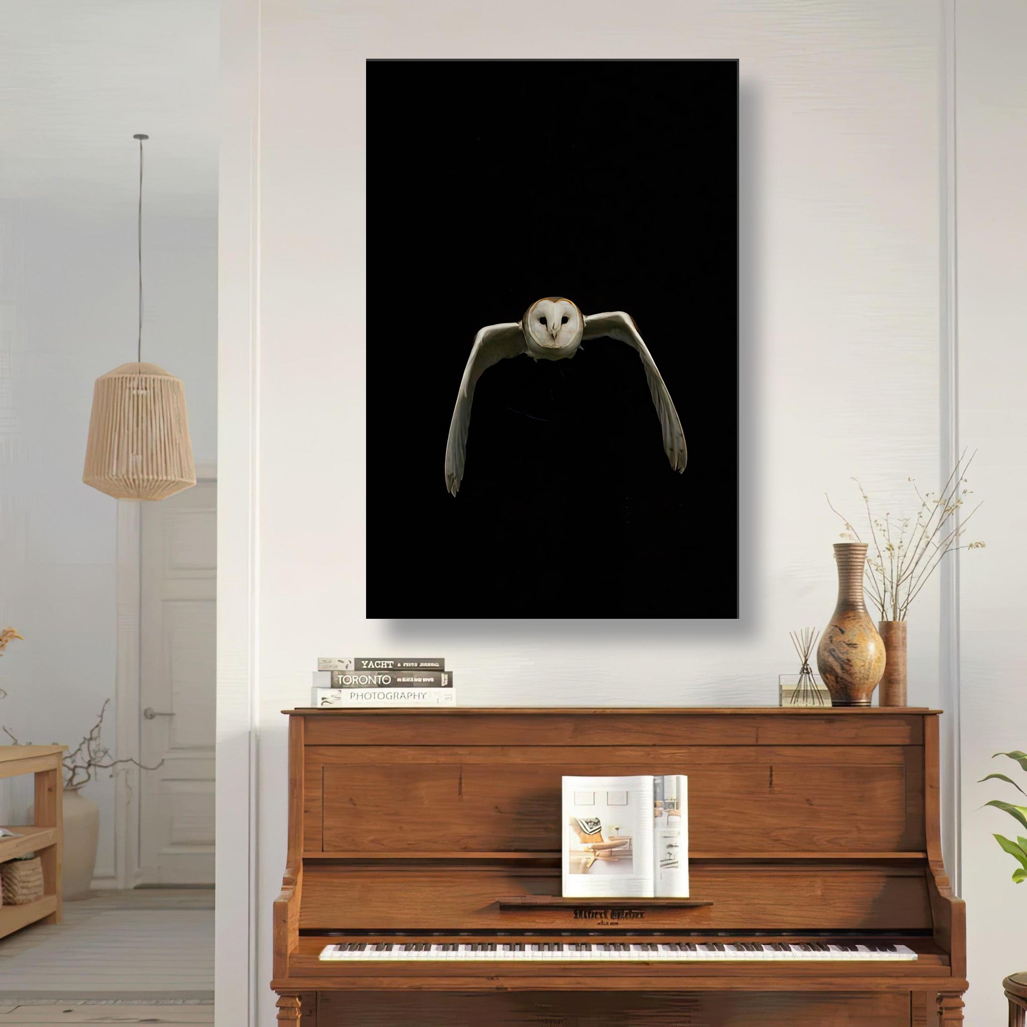 Owl canvas artwork displaying a majestic owl flying against a black background in a stylish interior setting.