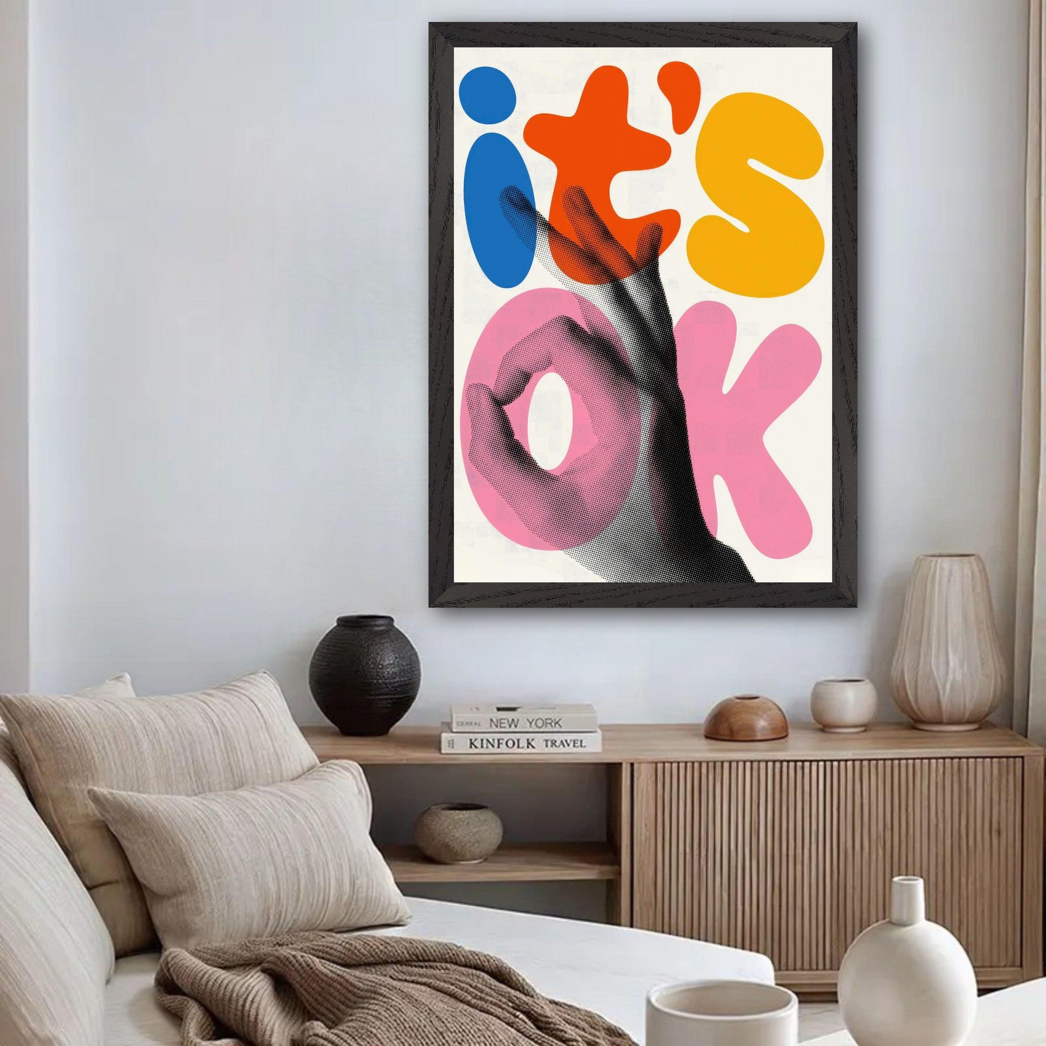 Vintage framed print featuring bold 'it's OK' typography and a halftone hand gesture in a stylish living room setting.