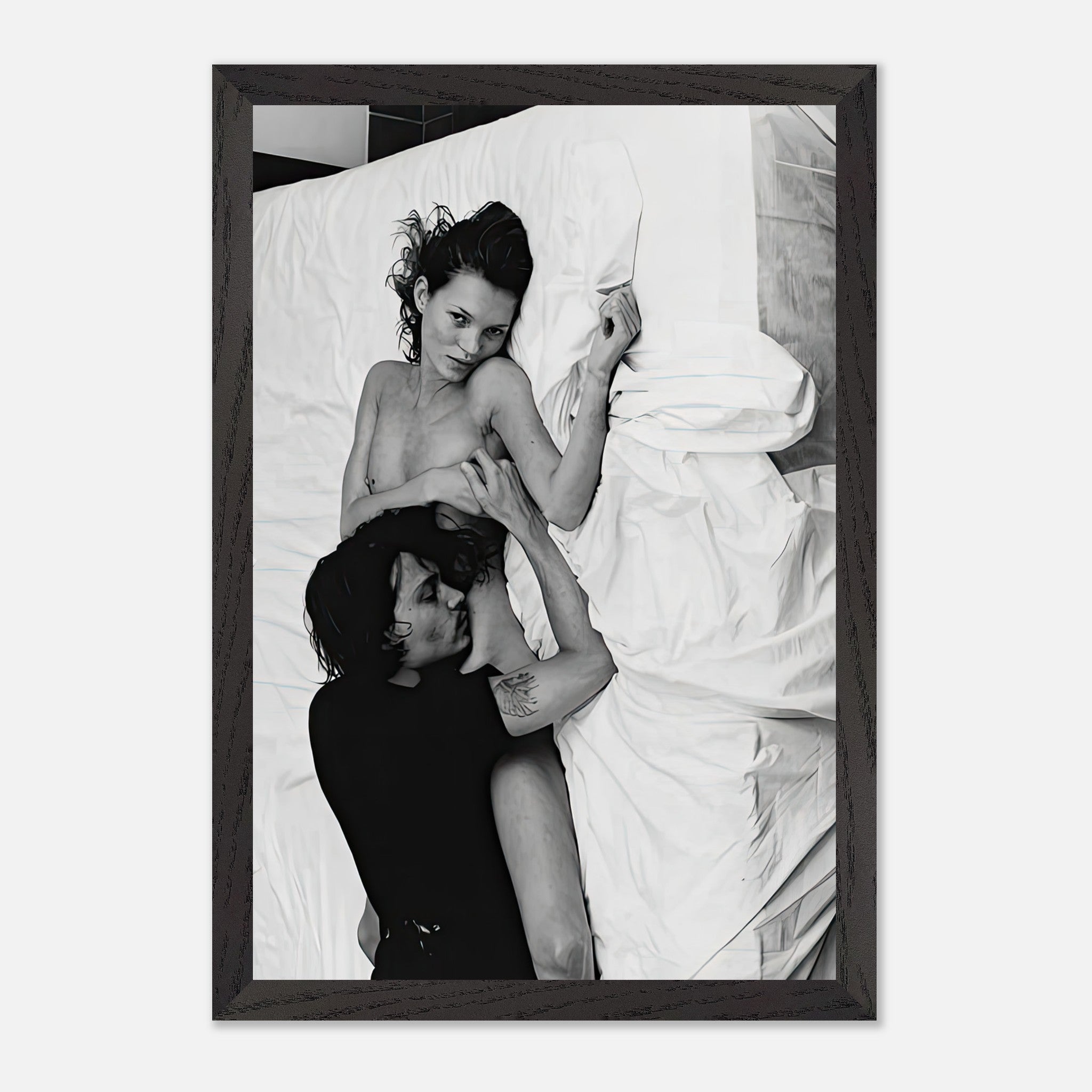 Black and white fine art print of a couple embracing in bed, capturing intimacy and emotion.