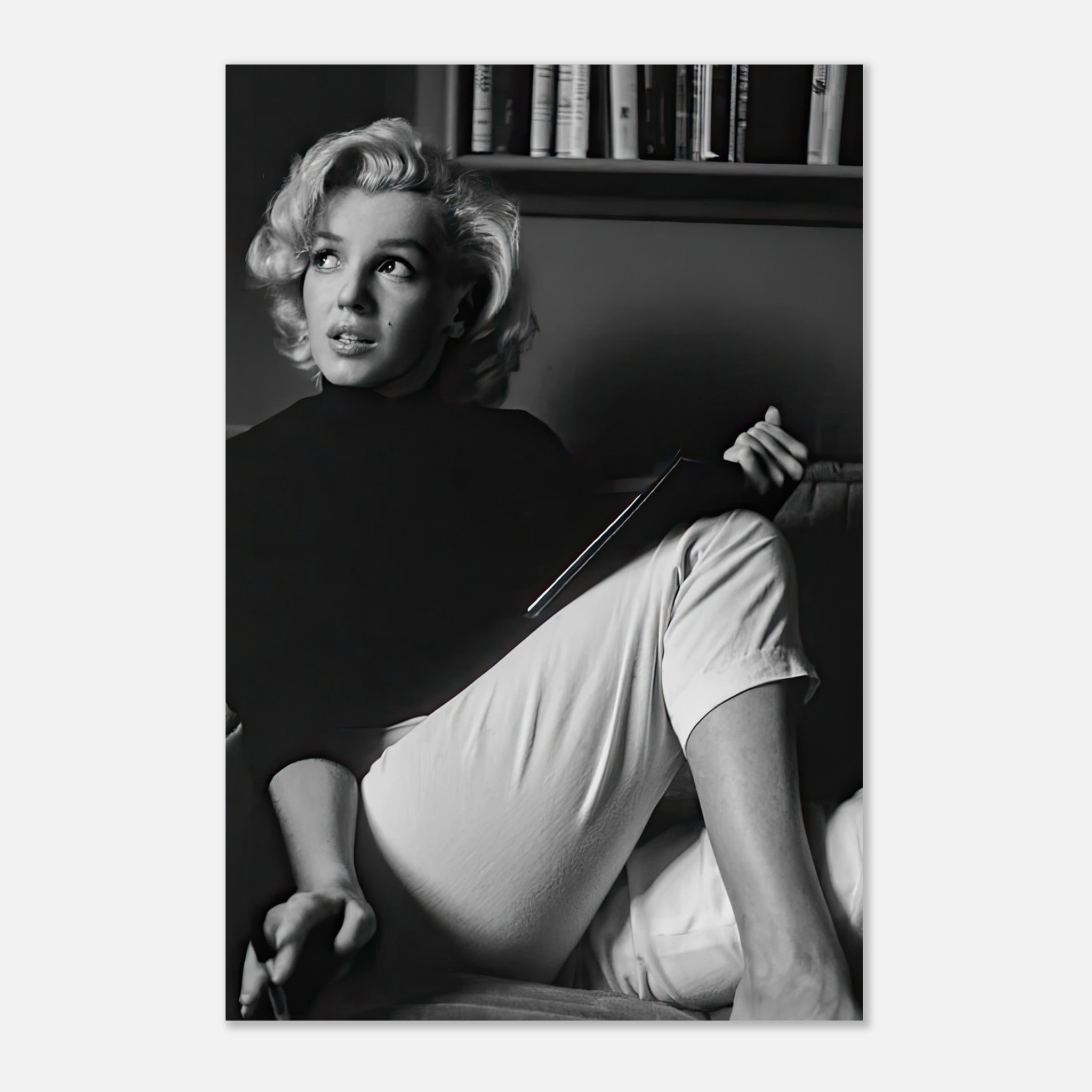 Marilyn Monroe reading a book in black-and-white, showcasing elegance and intellect in a serene atmosphere.