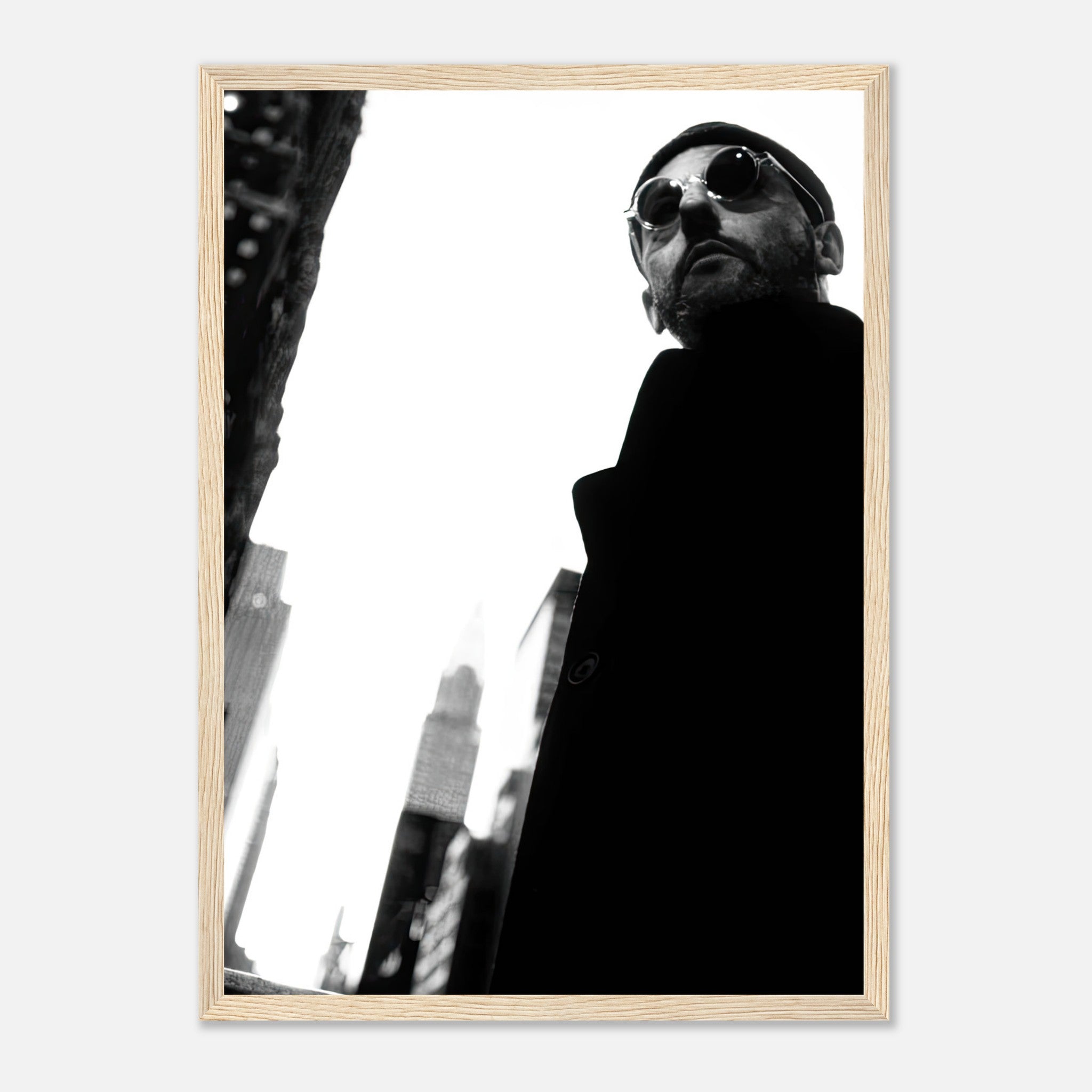Leon Photography framed print of Jean Reno in black-and-white, showcasing cinematic artistry against an urban backdrop.